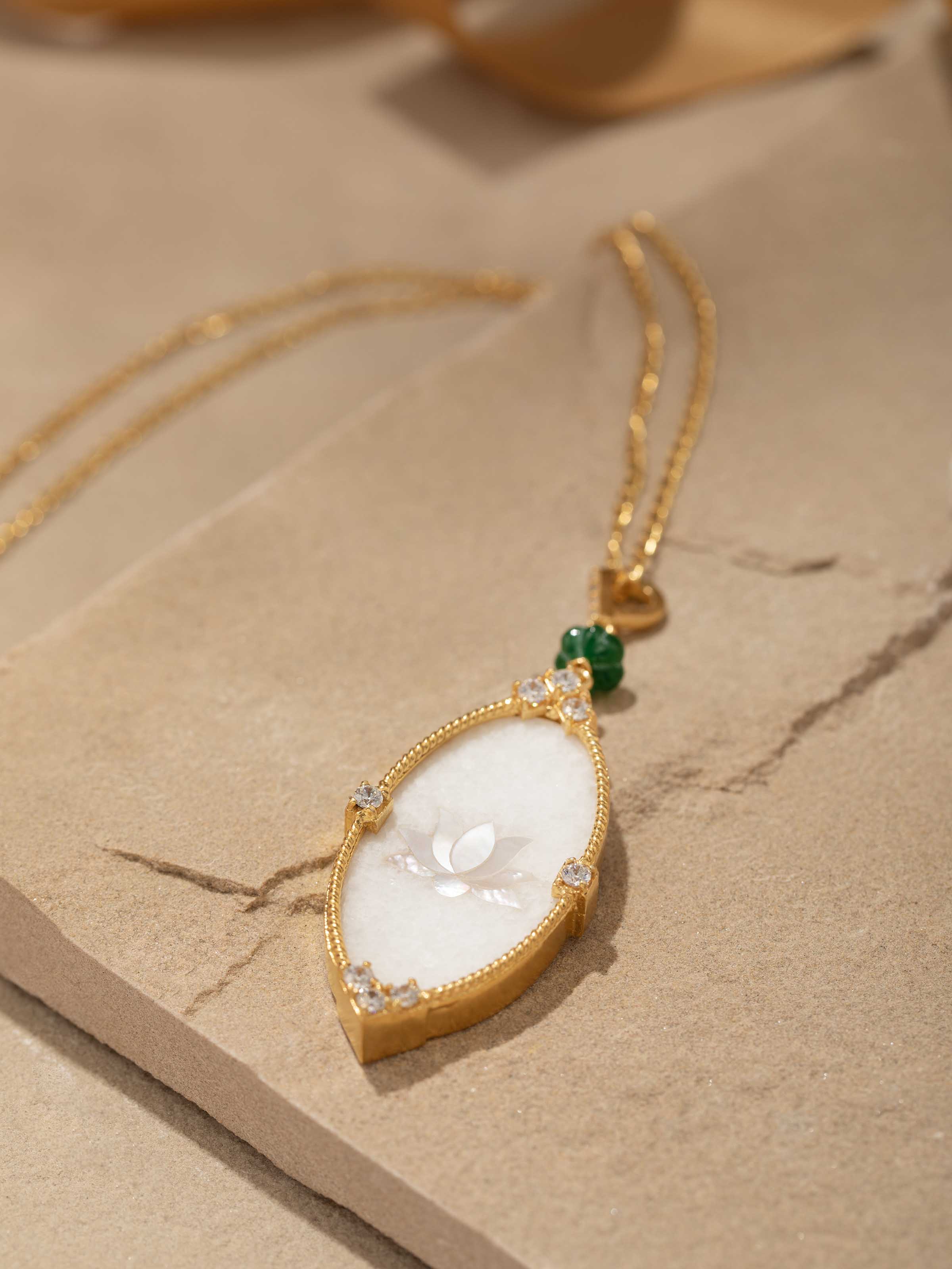 Display shot showing the full pendant and chain set arranged aesthetically