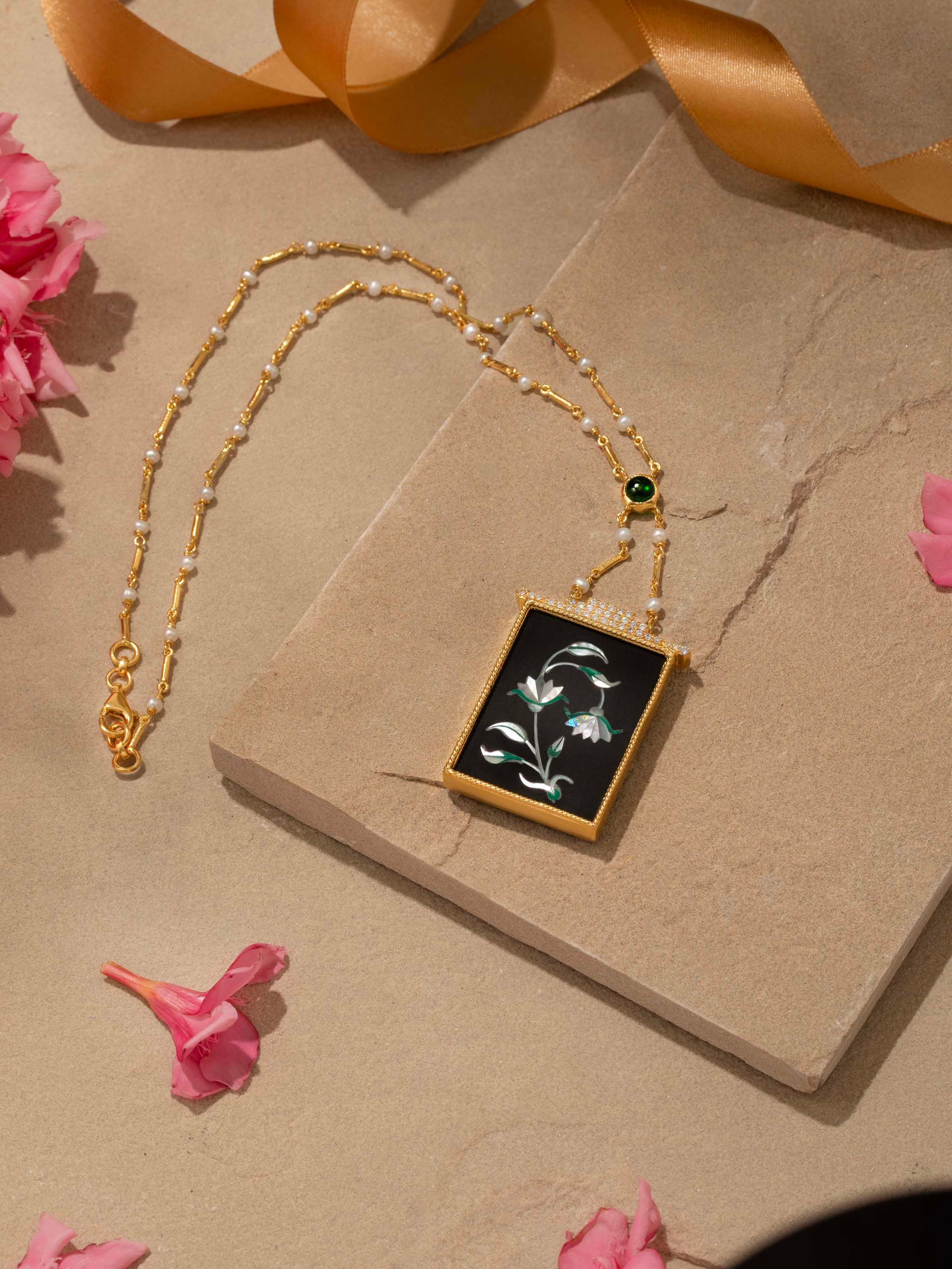 Detailed view of Pacchikari silver pendant and chain focusing on the intricate silverwork and design.