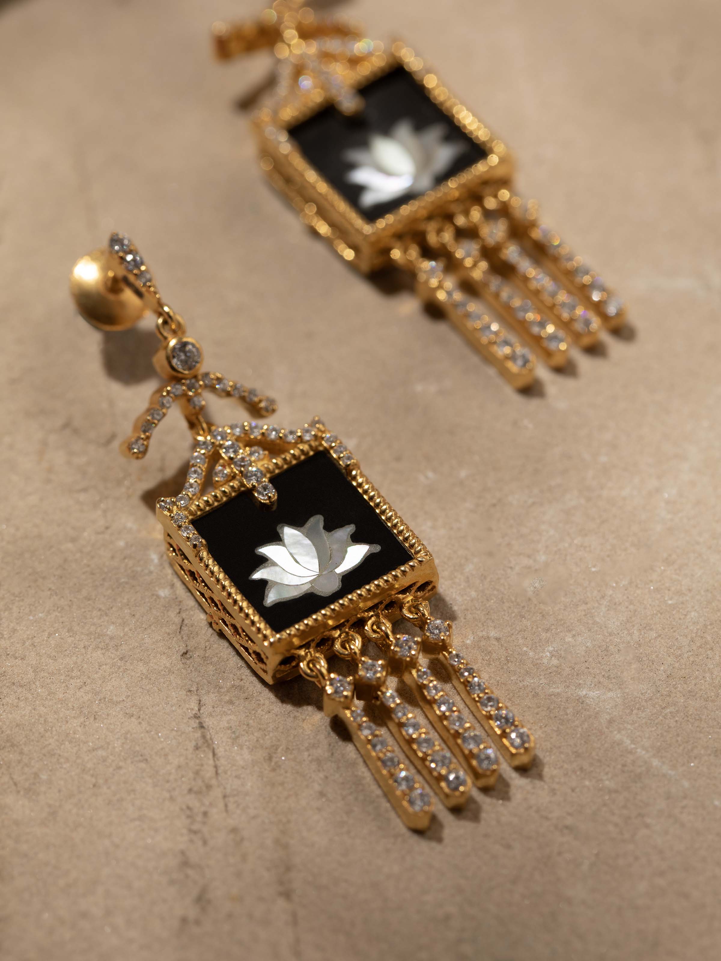 Detail close-up of Parchinkari silver drop earrings revealing fine craftsmanship and floral inlay artistry.