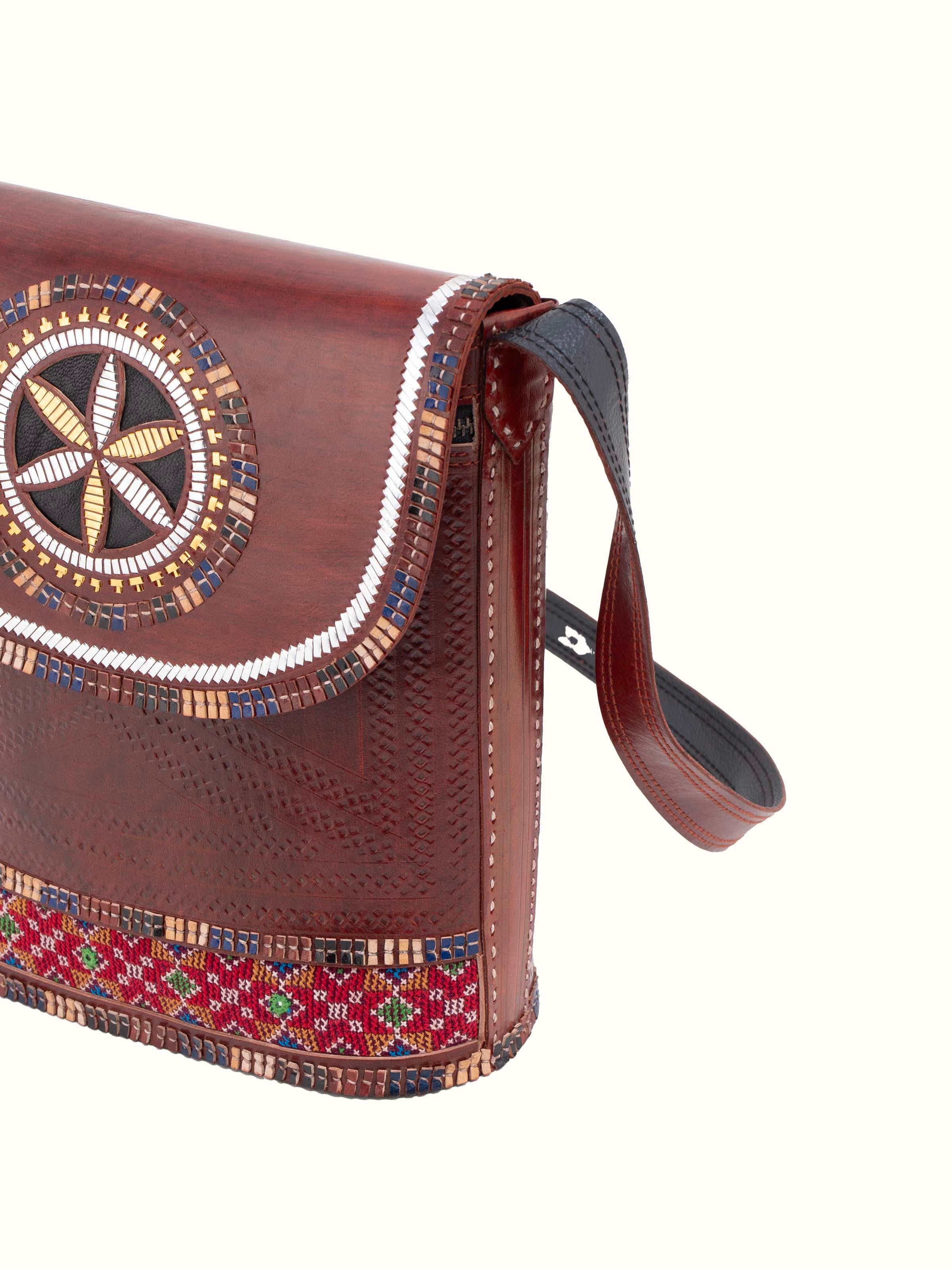 Angled view of Kutchi Leather Embroidered Sling Bag emphasizing the overall design and structure.