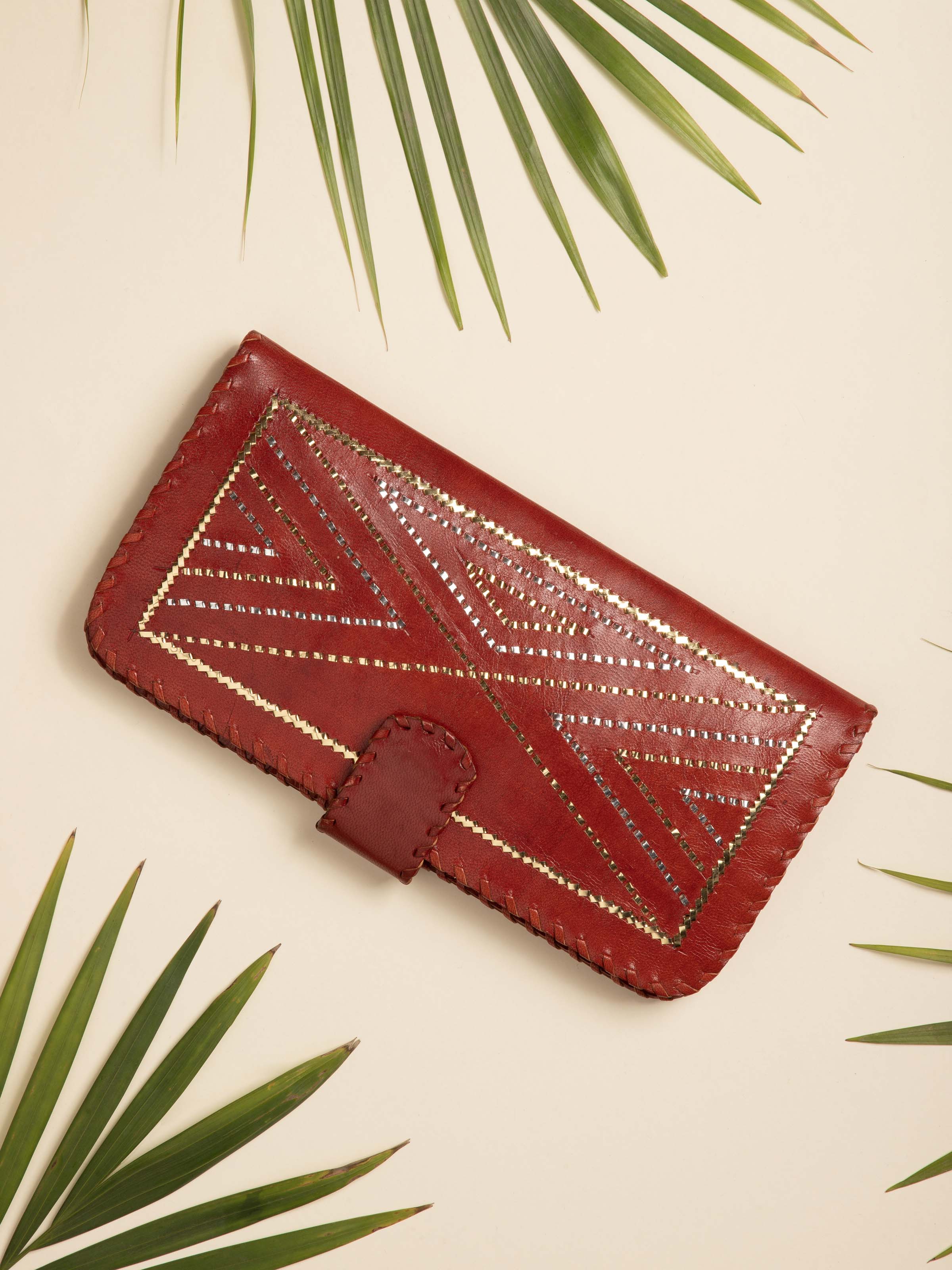 Angled view of Kutchi Leather Clutch with Embroidery highlighting its intricate patterns.