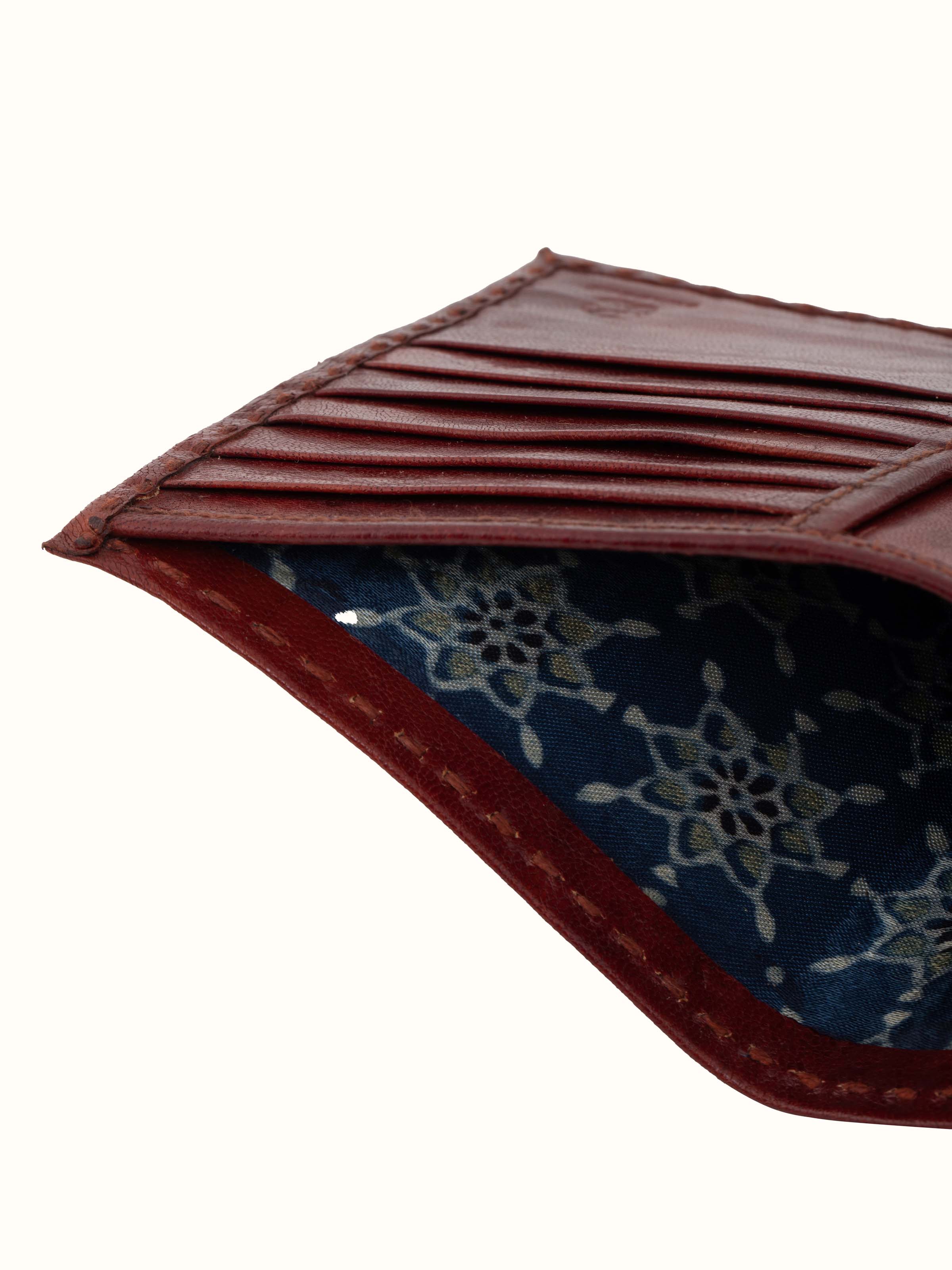 Back view of tan Kutchi leather embroidered wallet highlighting the closure and design details