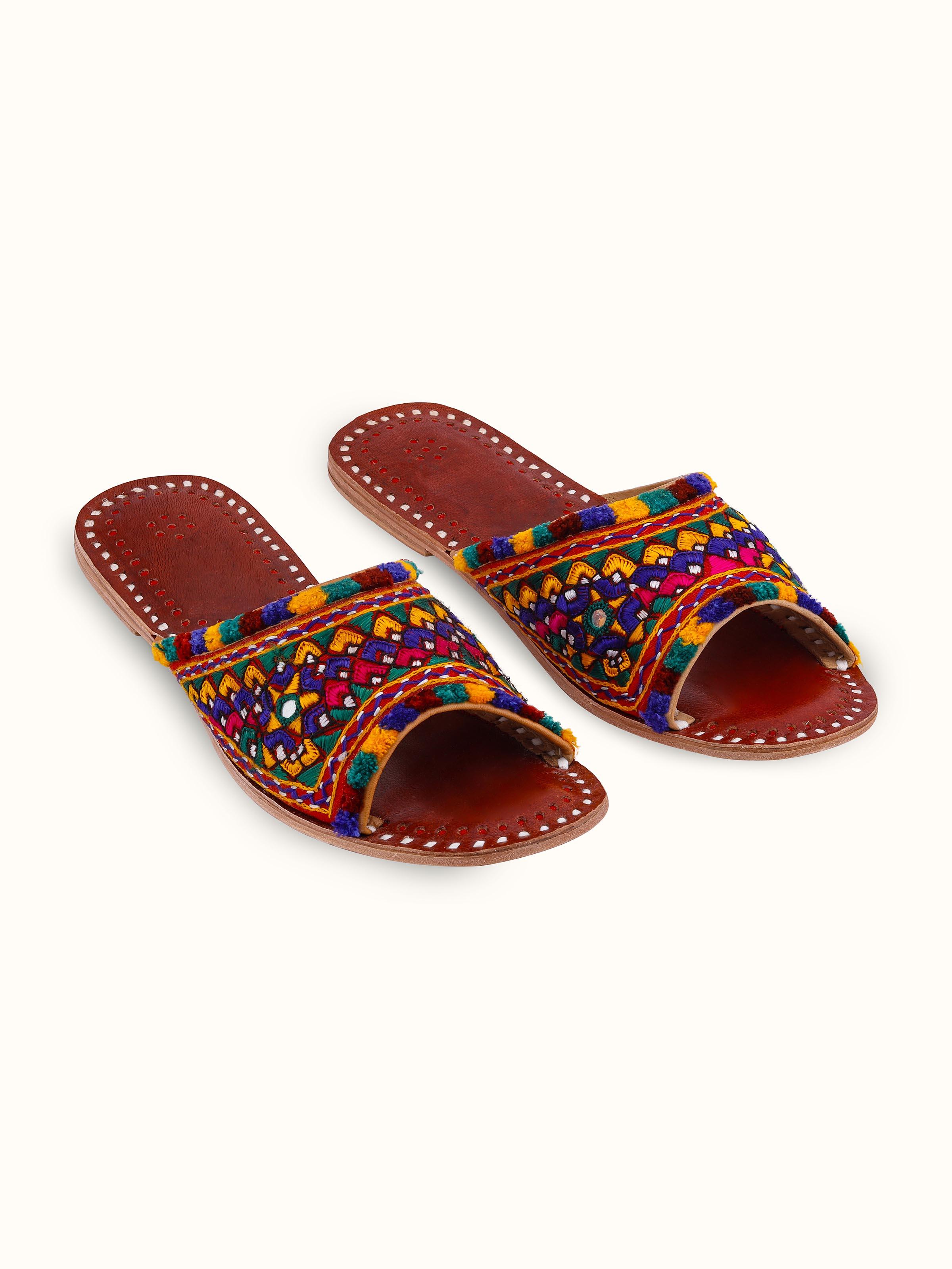 Front view of tan leather kutch embroidered slides with detailed kutch embroidery