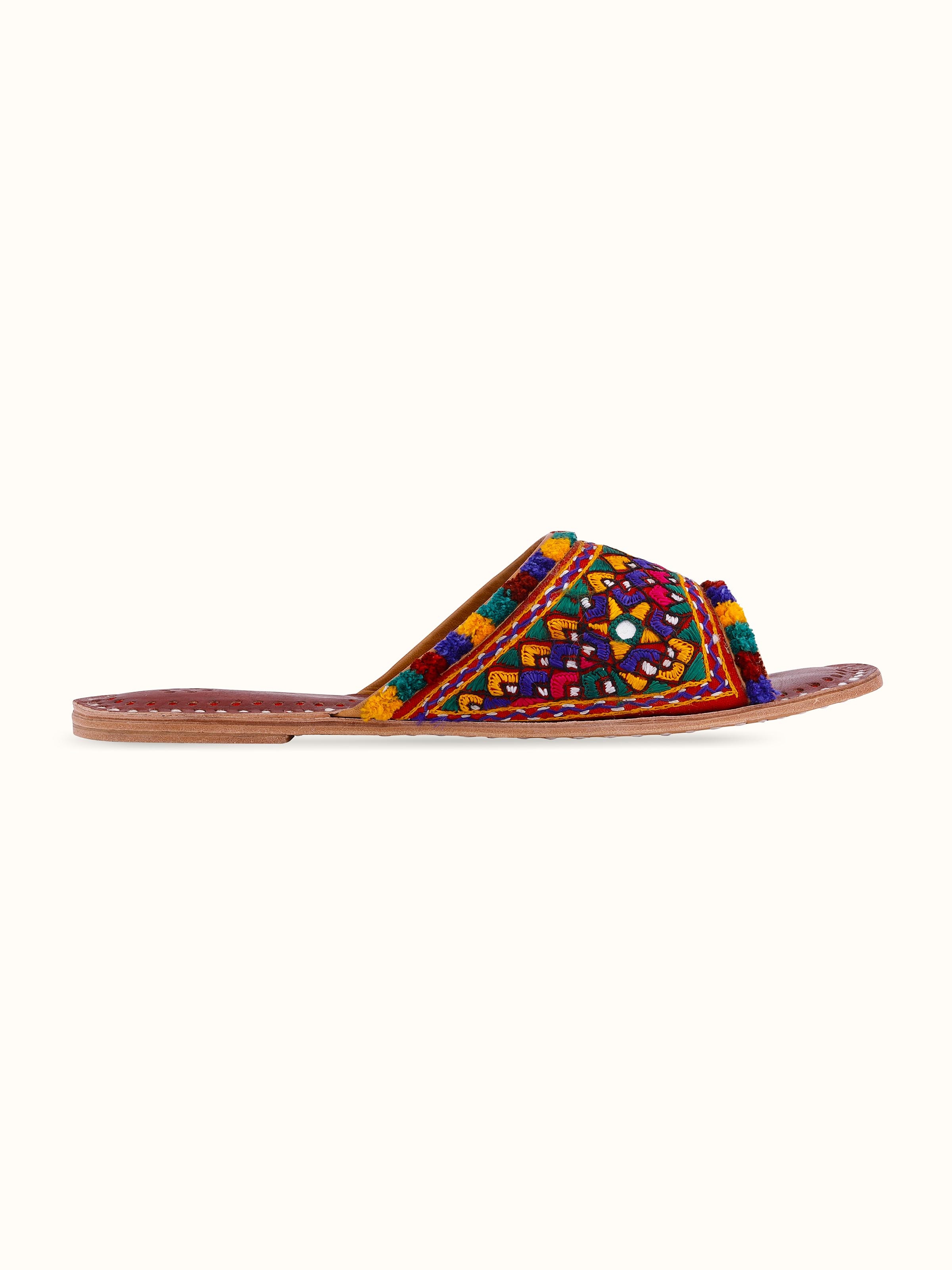 Back view of tan leather kutch embroidered slides showing overall design and craftsmanship