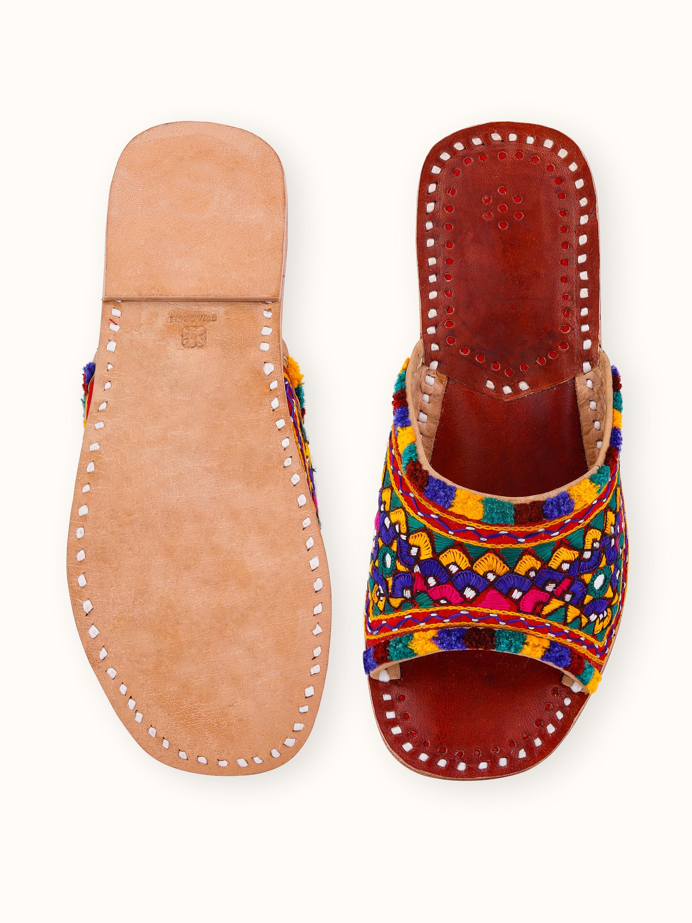 Detailed view of tan leather kutch embroidered slides emphasizing the kutch work
