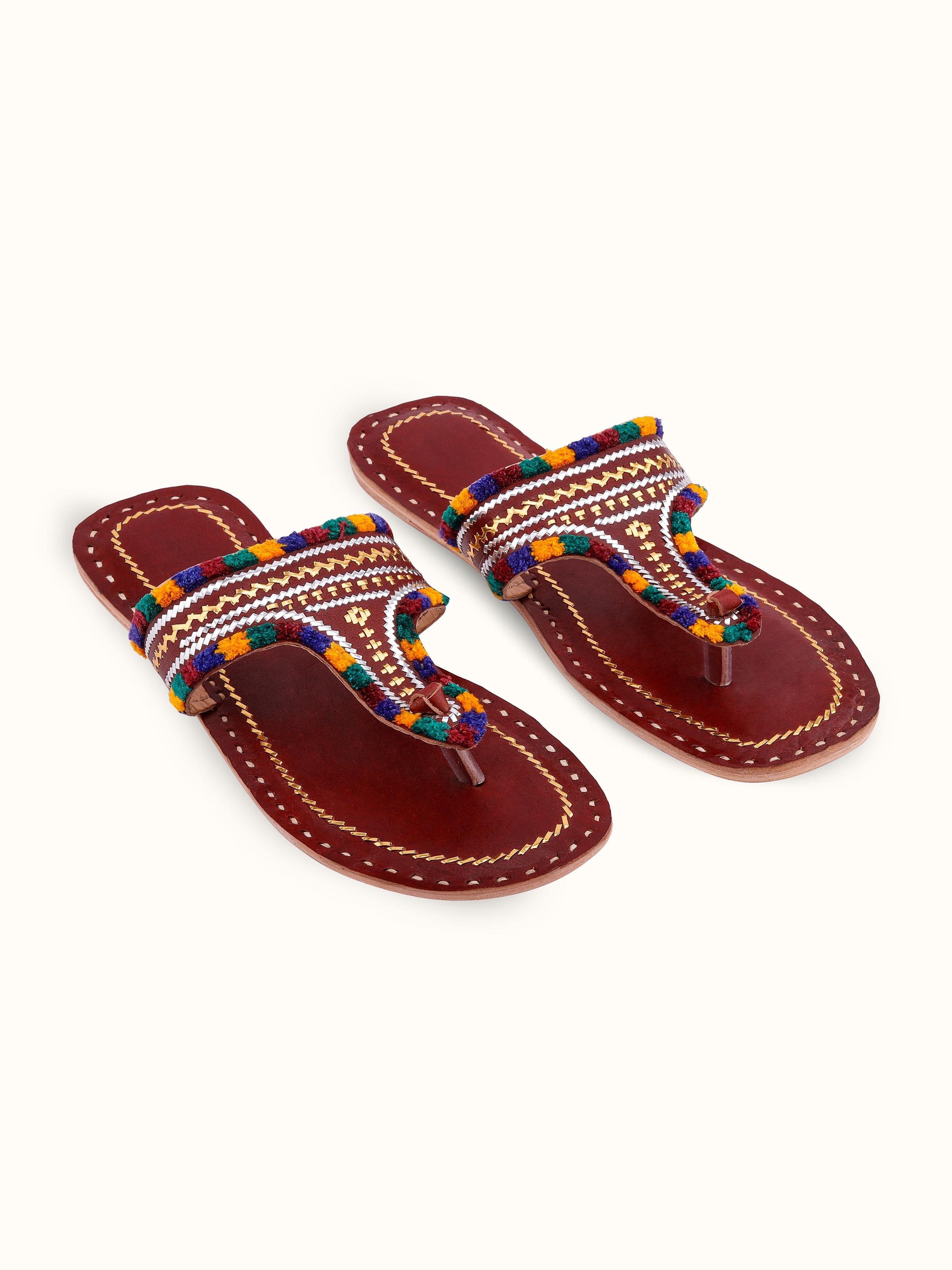 Front view of tan leather kutch stitched flats showcasing traditional embroidery