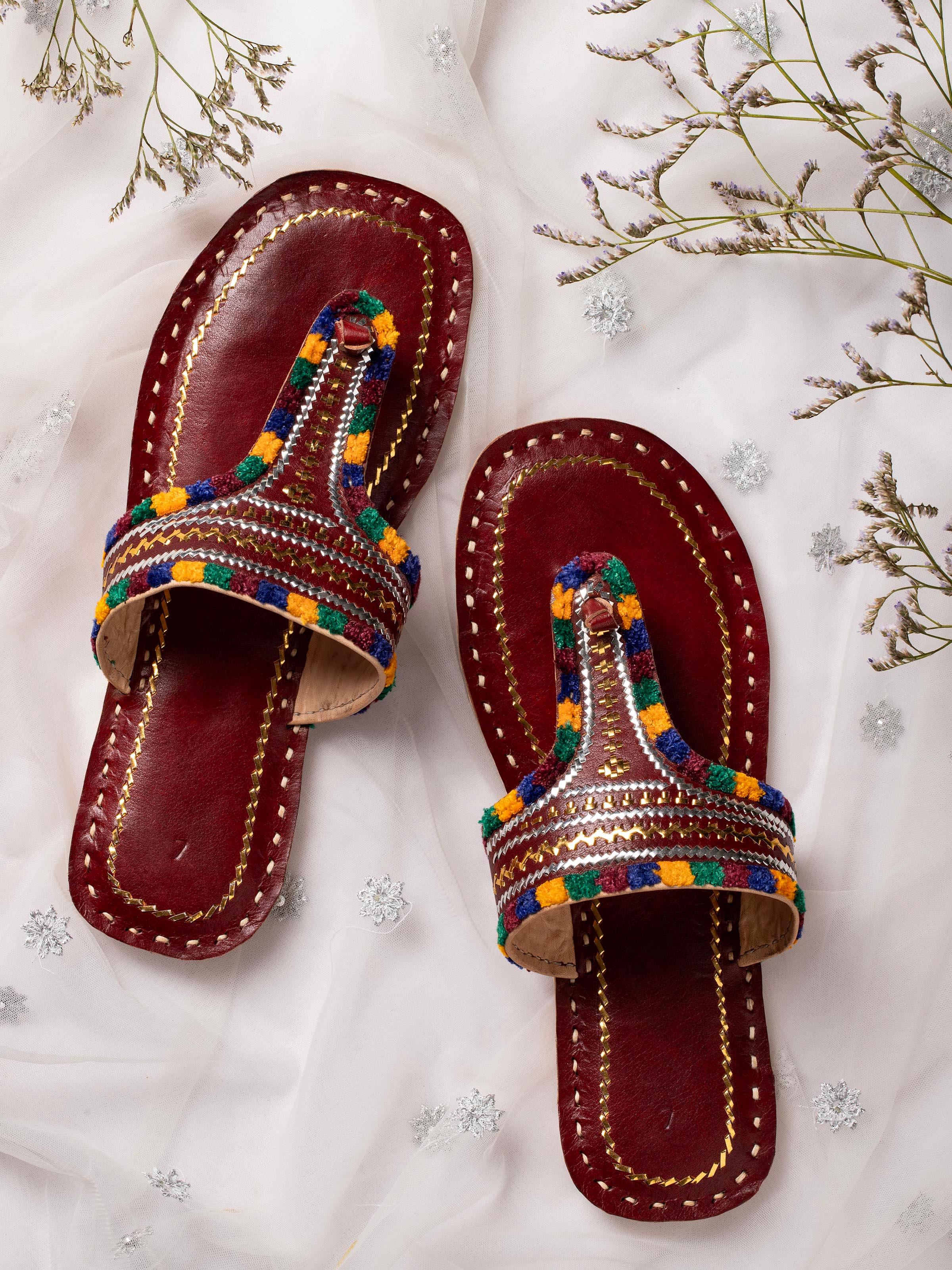 Side view of tan leather kutch stitched flats emphasizing detailed stitching