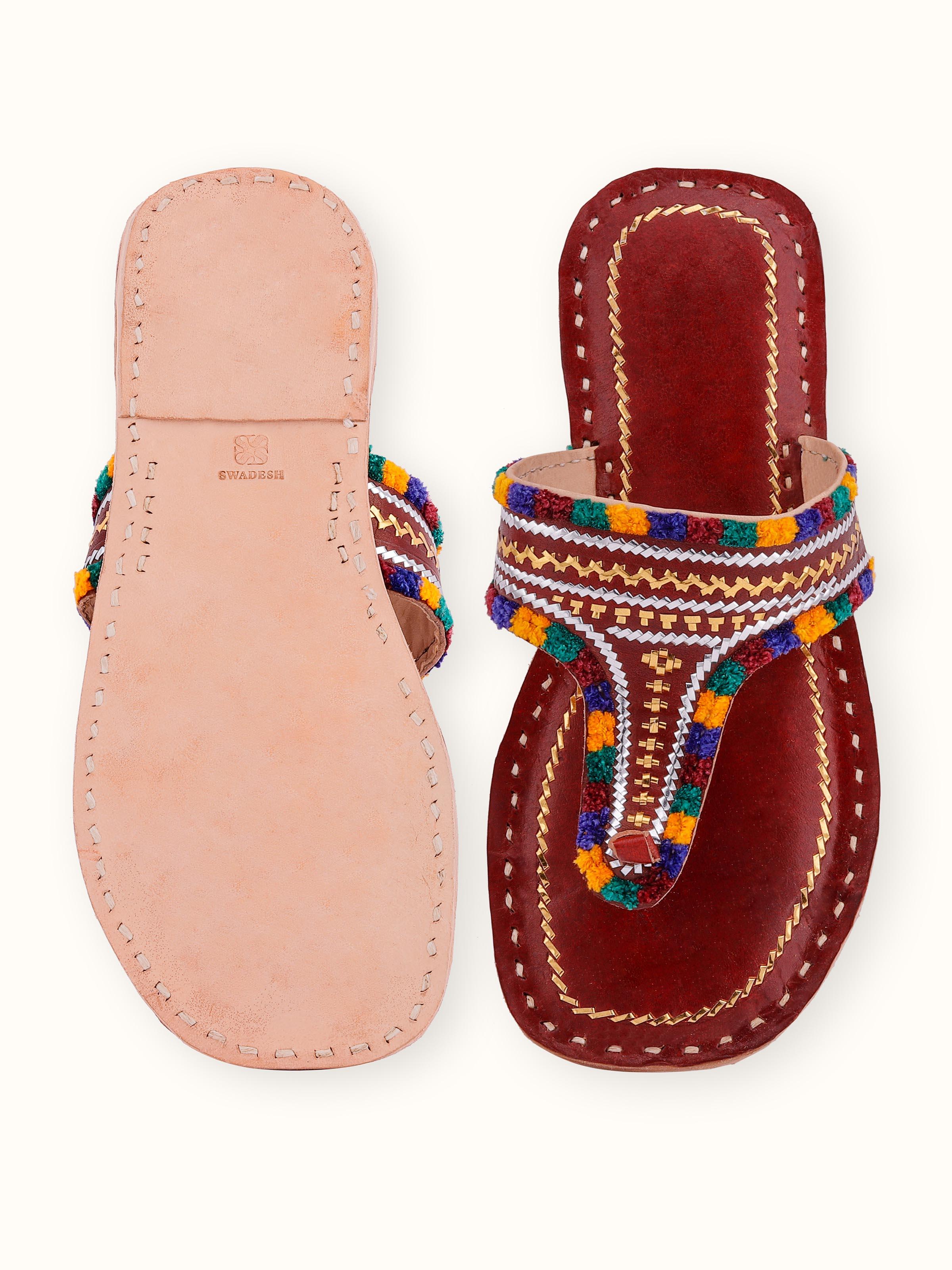 Angled view of tan leather kutch stitched flats showcasing elegant design