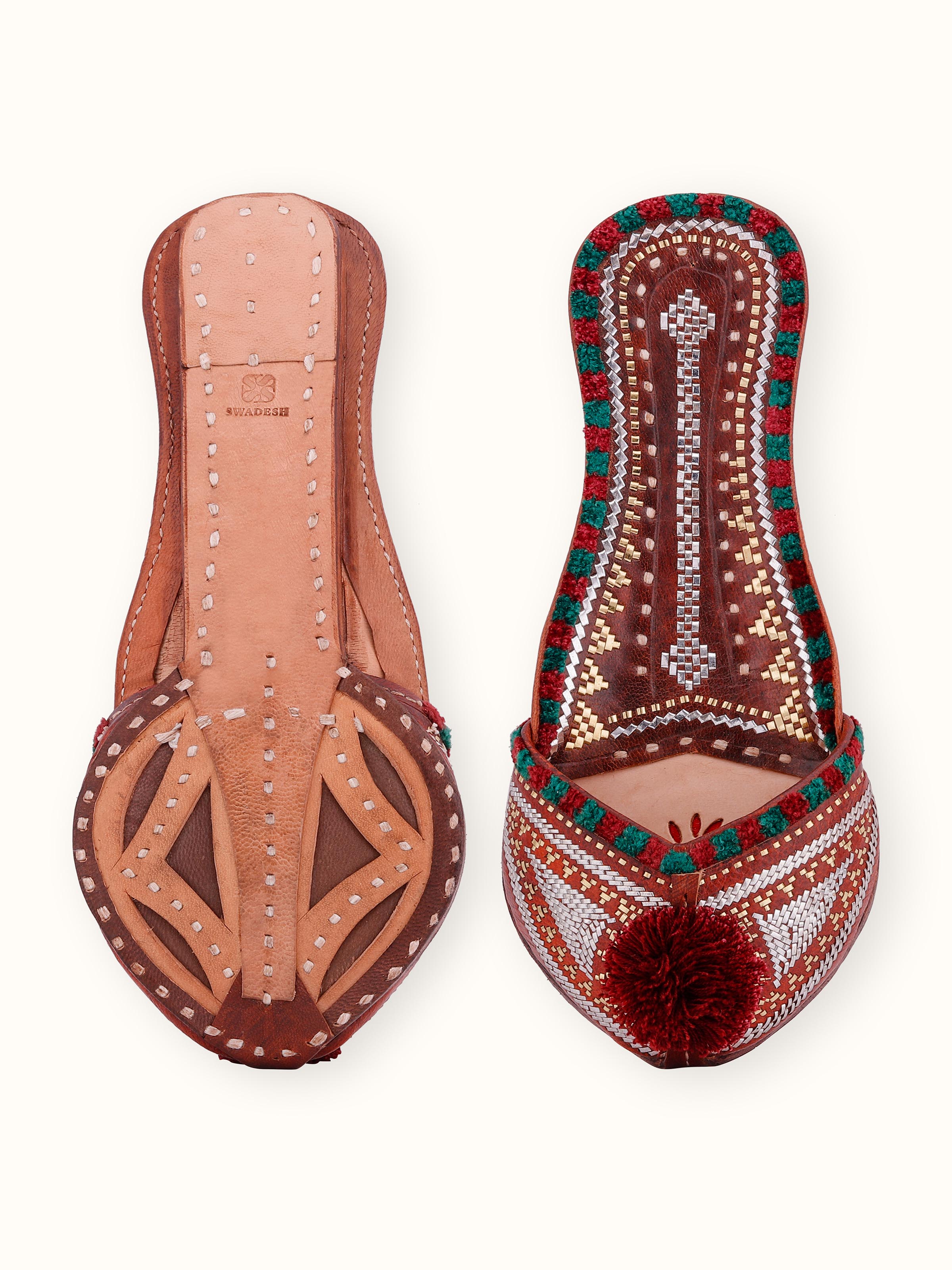 Back view of tan leather Kutch juttis highlighting design and craftsmanship