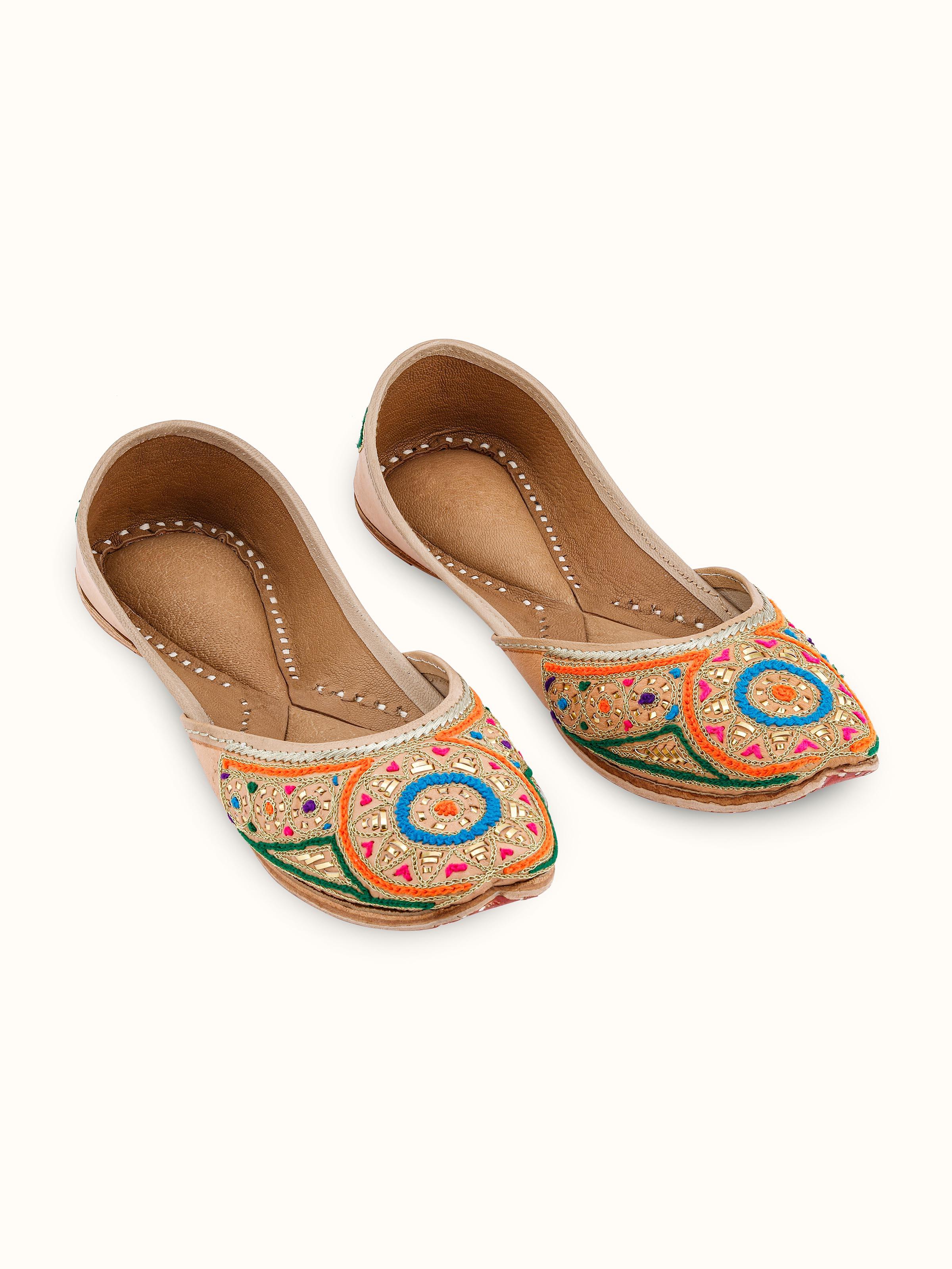 Front view of Tan Leather Haryana Embroidered Juttis featuring intricate embroidery and design.