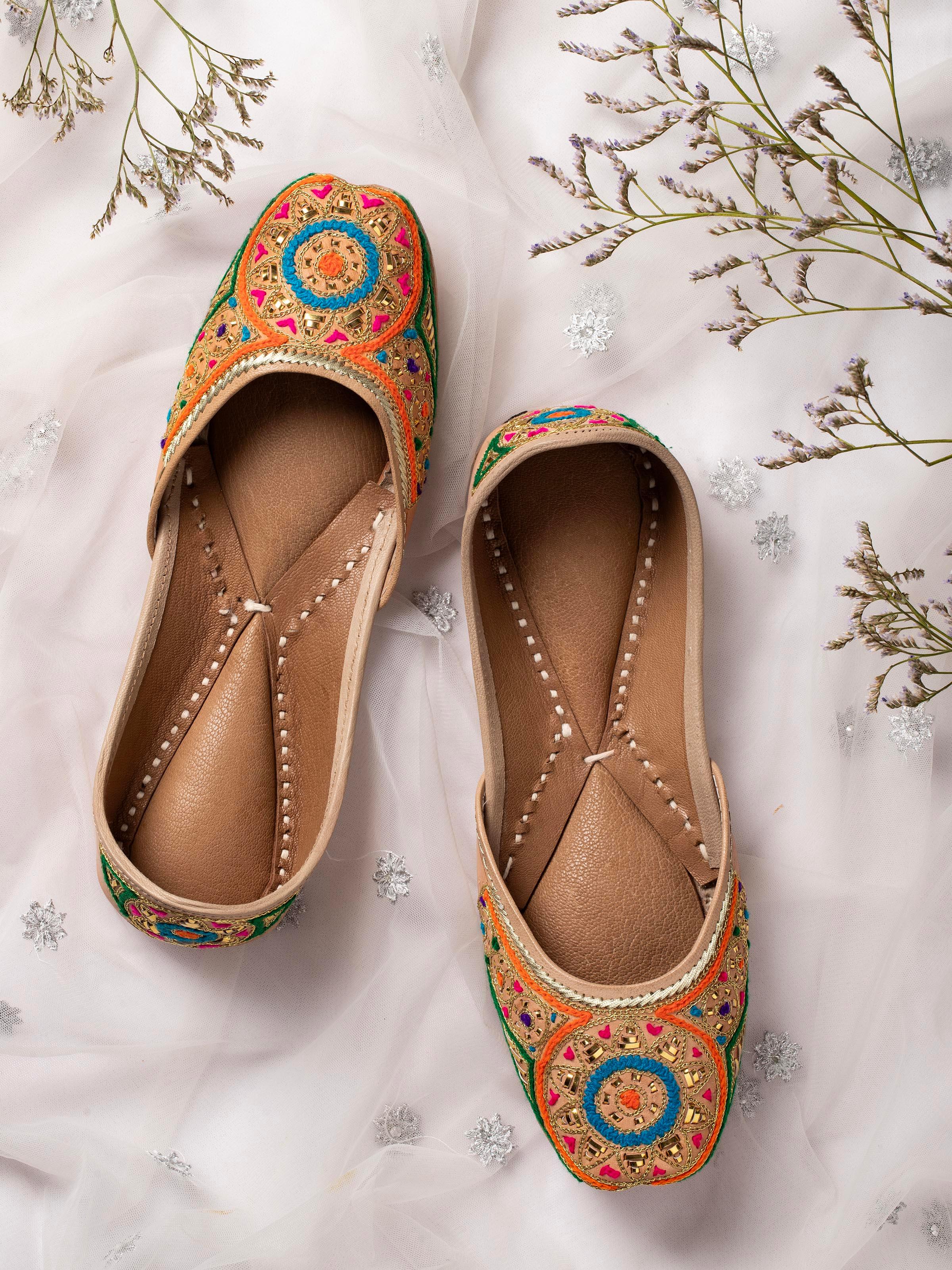 Side view of Tan Leather Haryana Embroidered Juttis focusing on the embroidered details and shape.