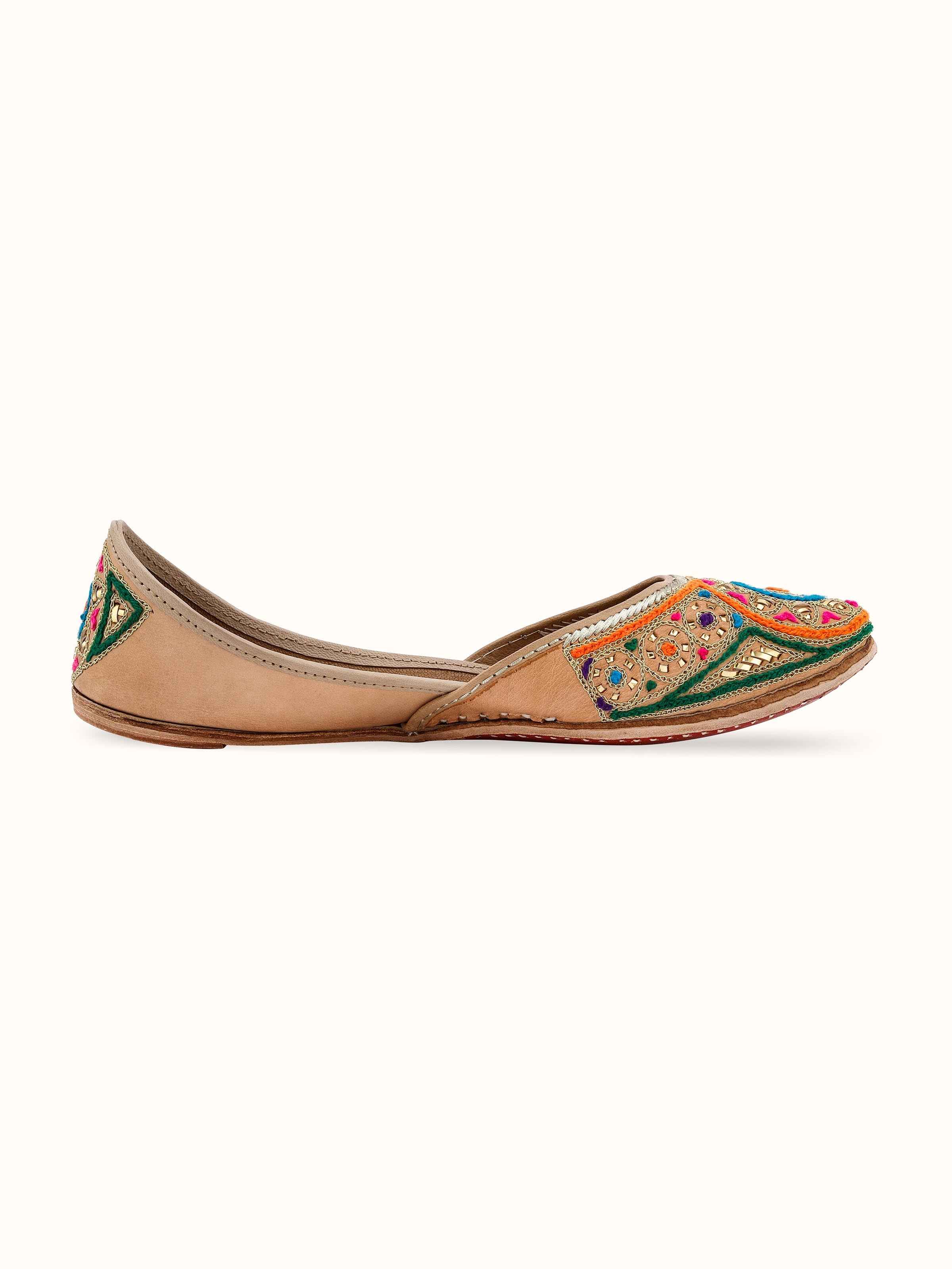 Angled view of Tan Leather Haryana Embroidered Juttis highlighting the detailed craftsmanship.
