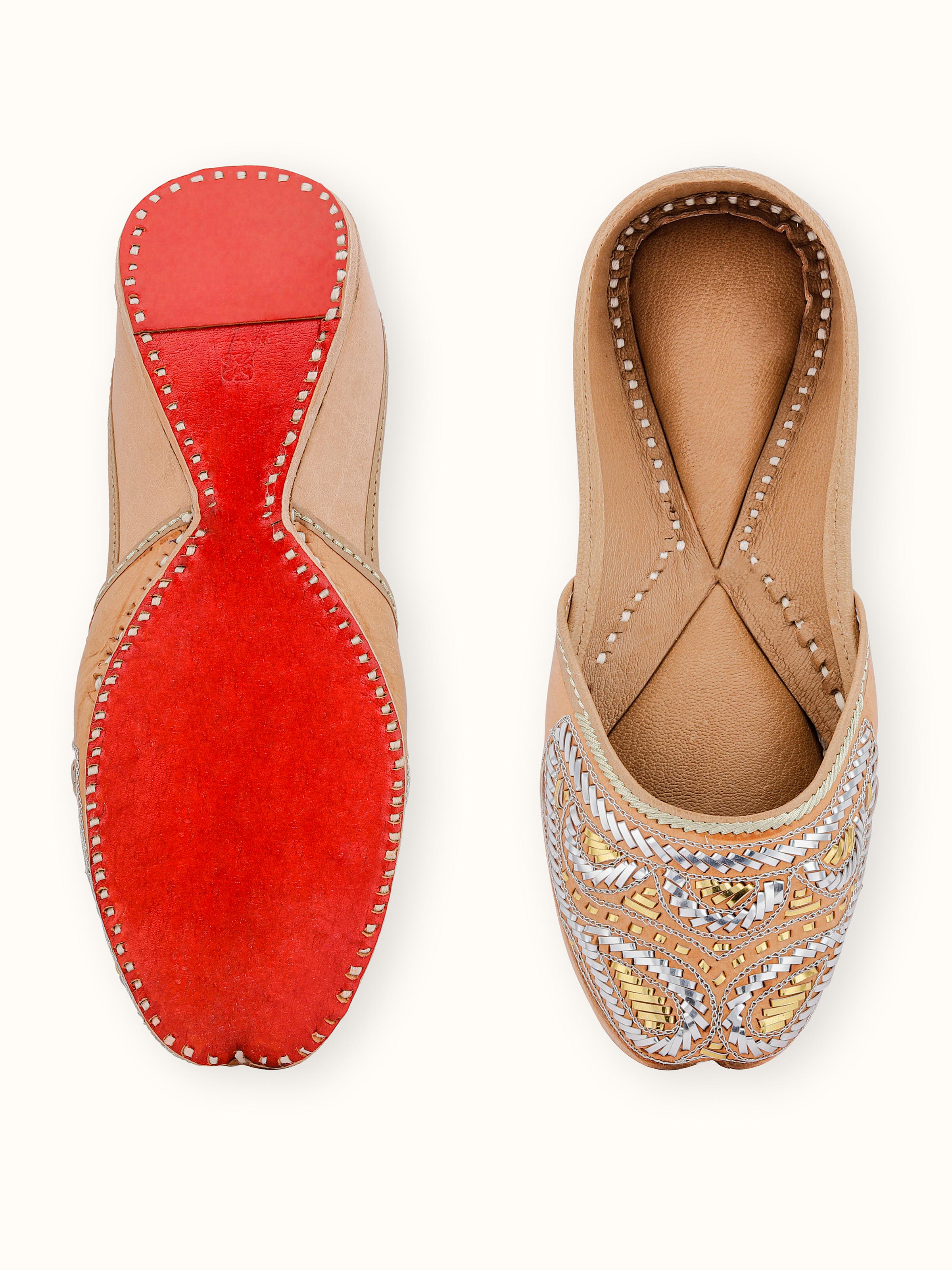 Top view of Ecru Leather Haryana Juttis revealing strap placement and sole details.