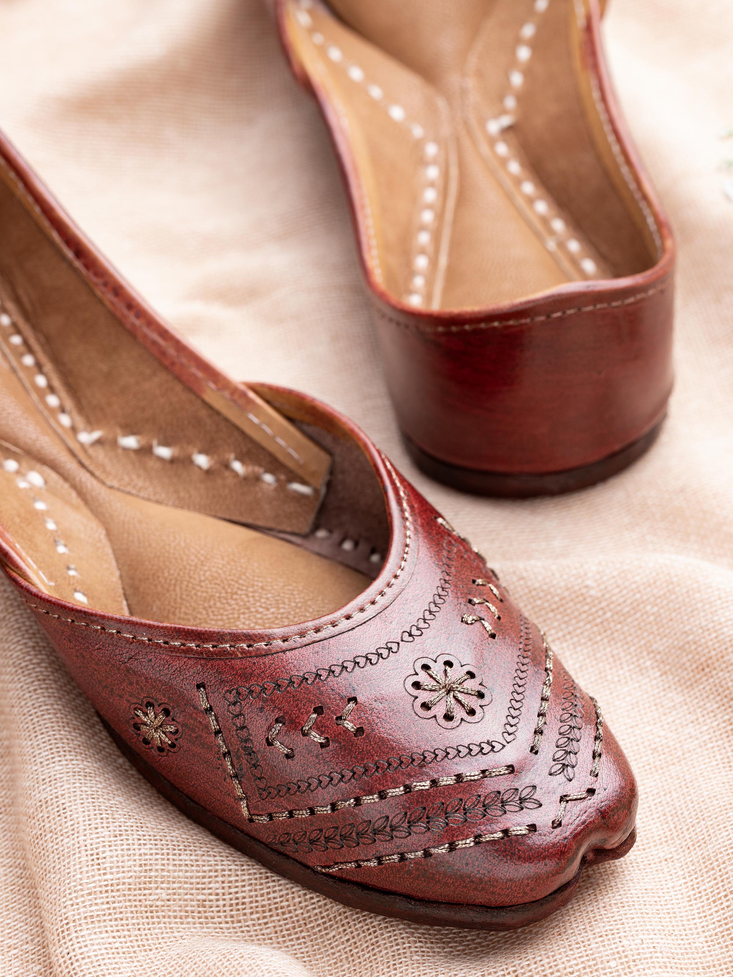 Close-up of tan leather Haryana juttis showcasing leather texture and craftsmanship