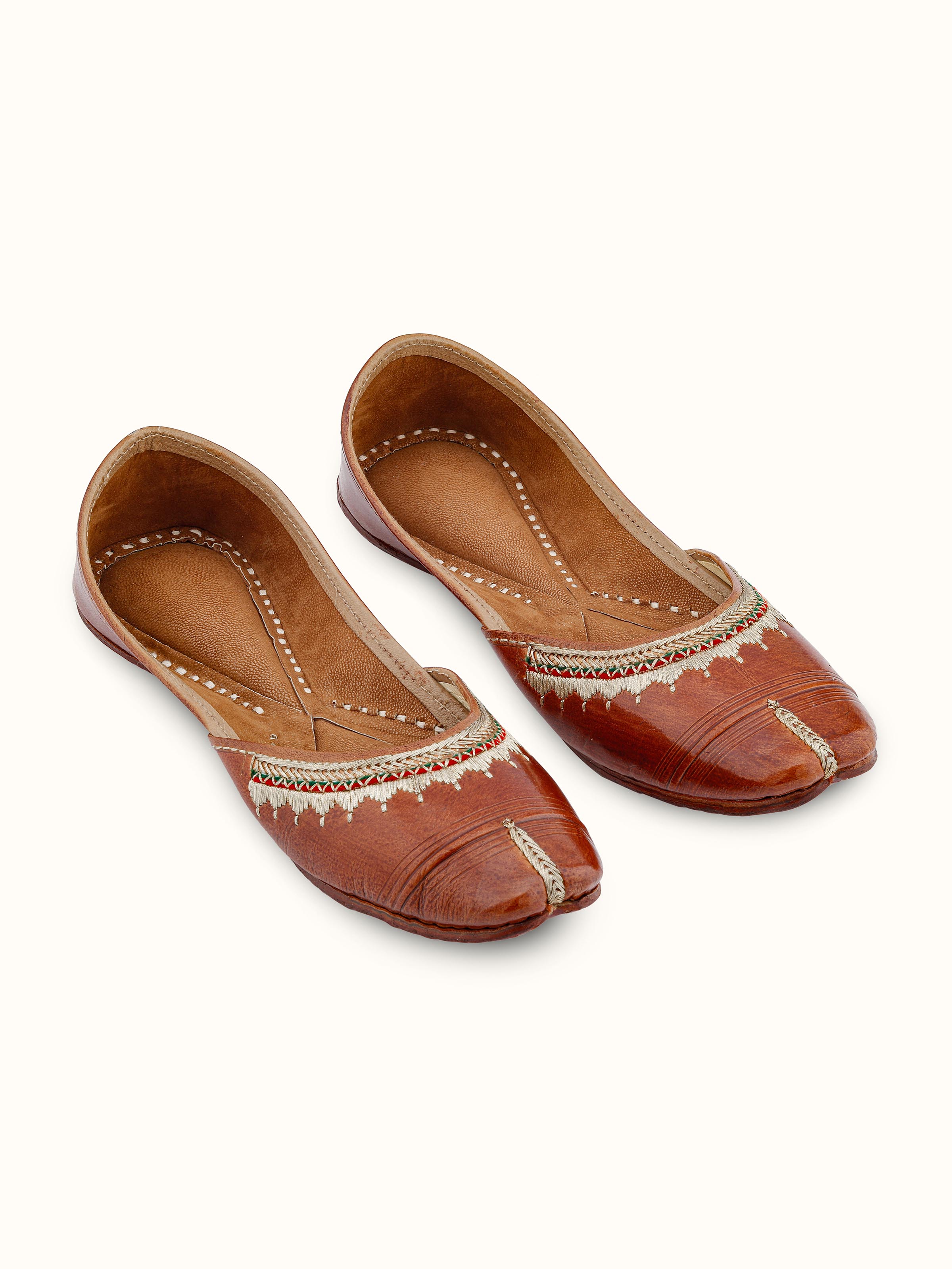 Front view of tan leather haryana juttis showcasing traditional design and craftsmanship