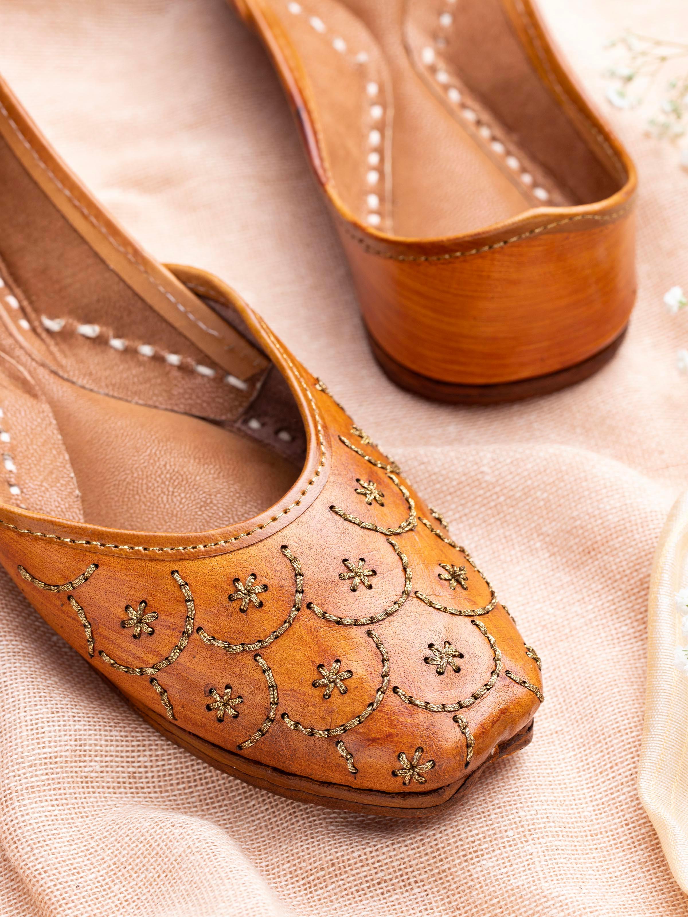 Close-up of Mustard Leather Haryana Juttis focusing on the intricate embroidery and leather texture.