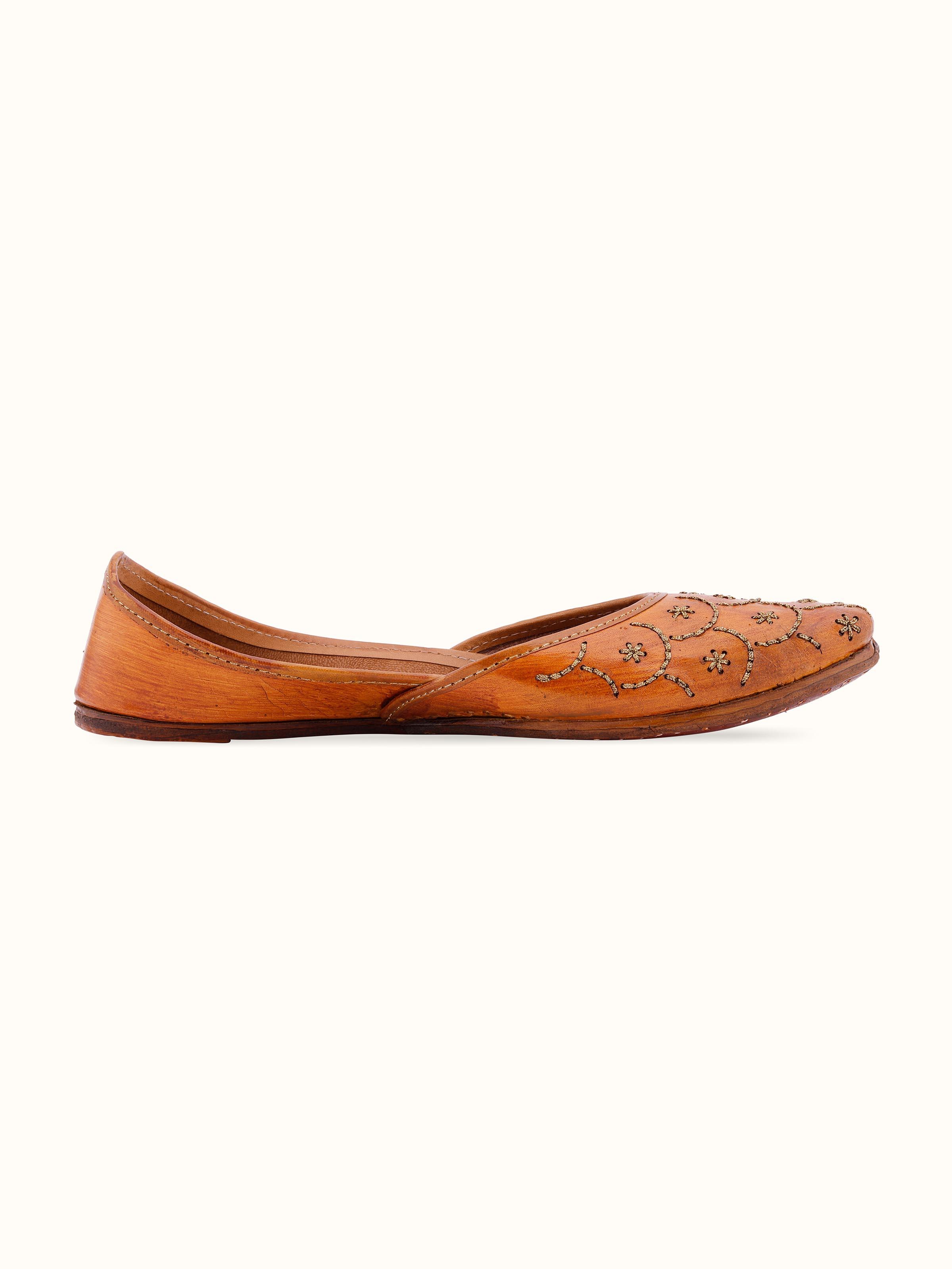 Angled view of Mustard Leather Haryana Juttis showcasing overall shape and design.