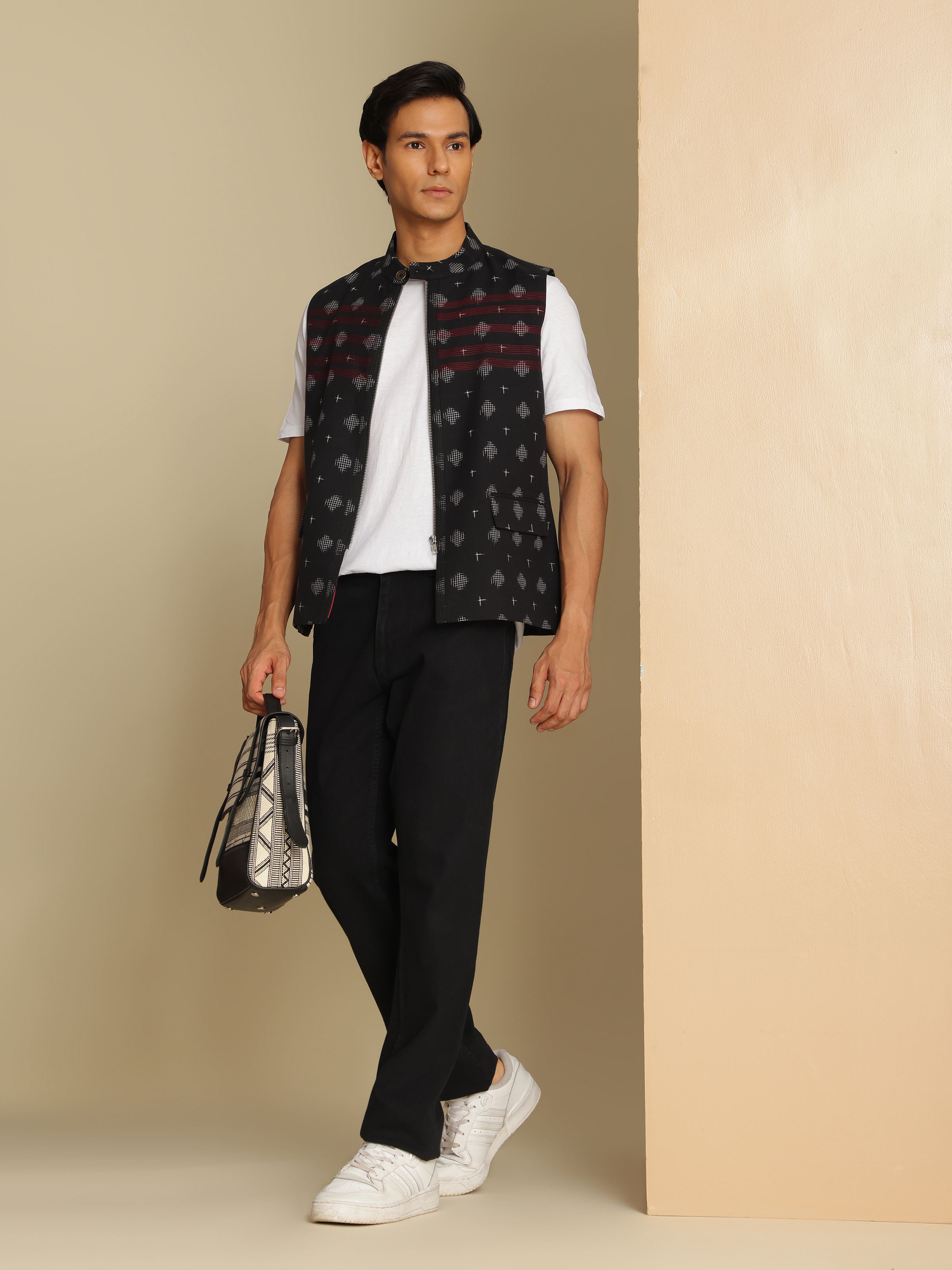 Woman styling black Telangana Ikat jacket over a white kurta for a layered ethnic look.