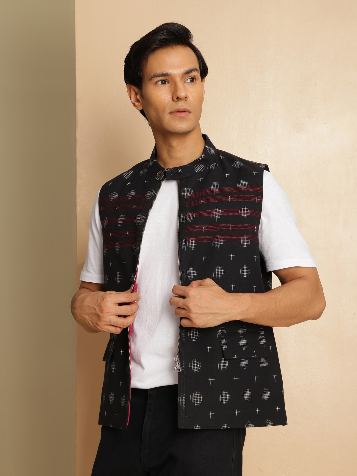 Angled view of sleeveless Ikat jacket revealing its handloom weave and tailored fit.