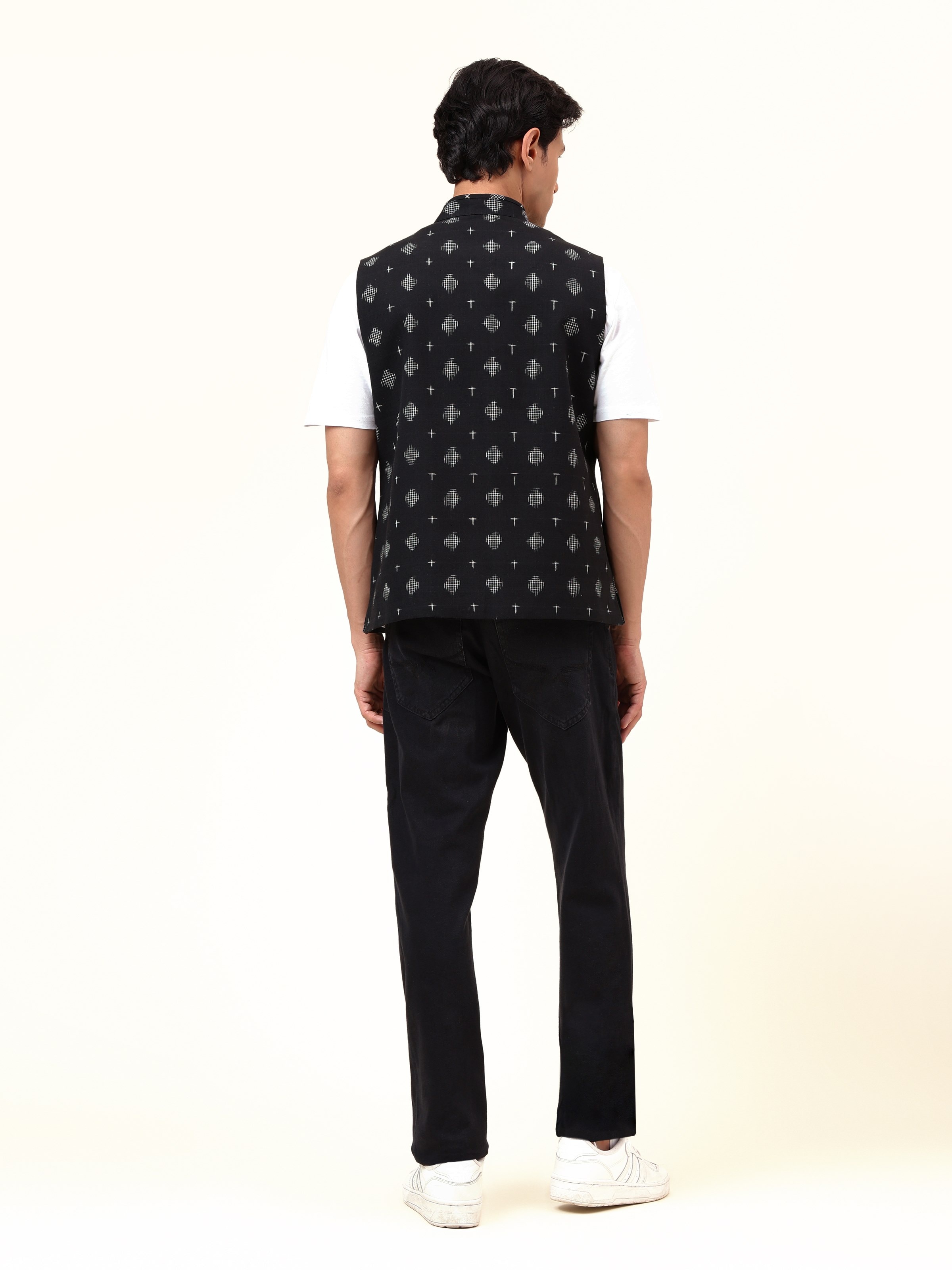 Back view of black cotton Ikat jacket showing full Ikat weave continuity and cut.