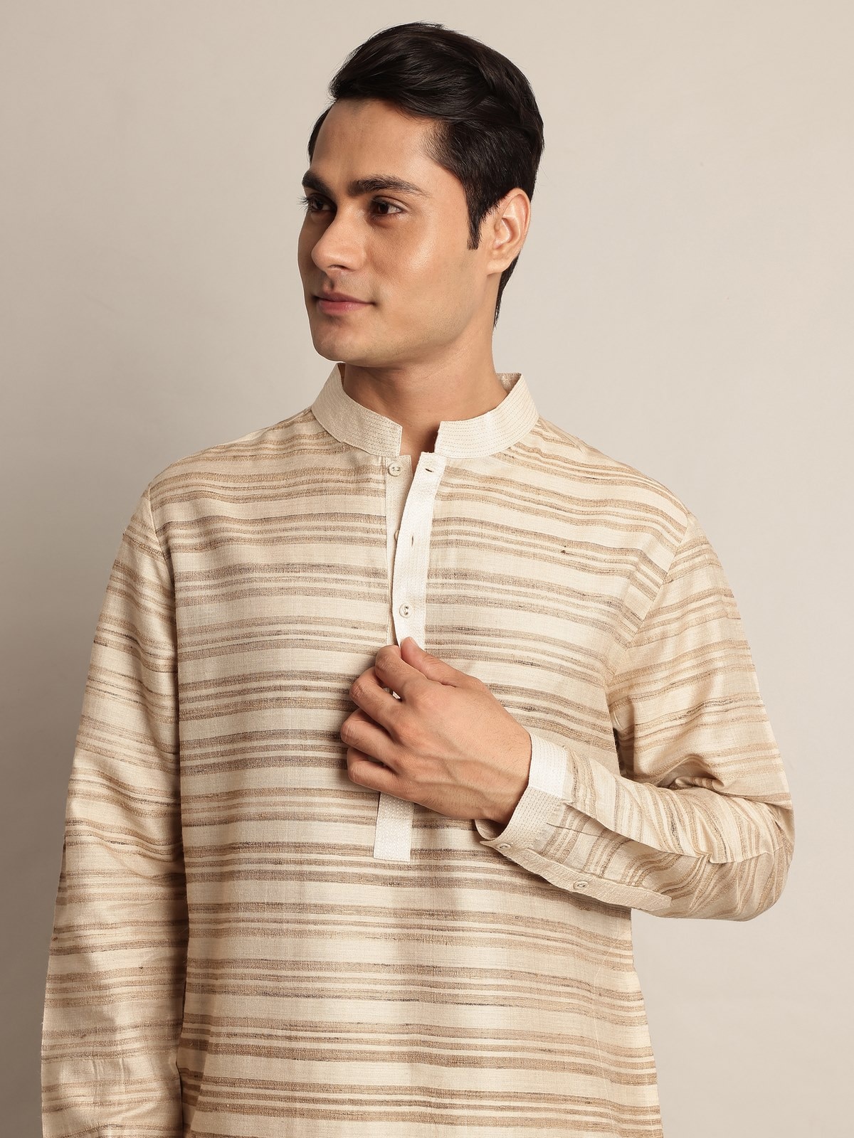 Side pose of model in brown Tussar silk long kurta, revealing side profile and fabric texture.