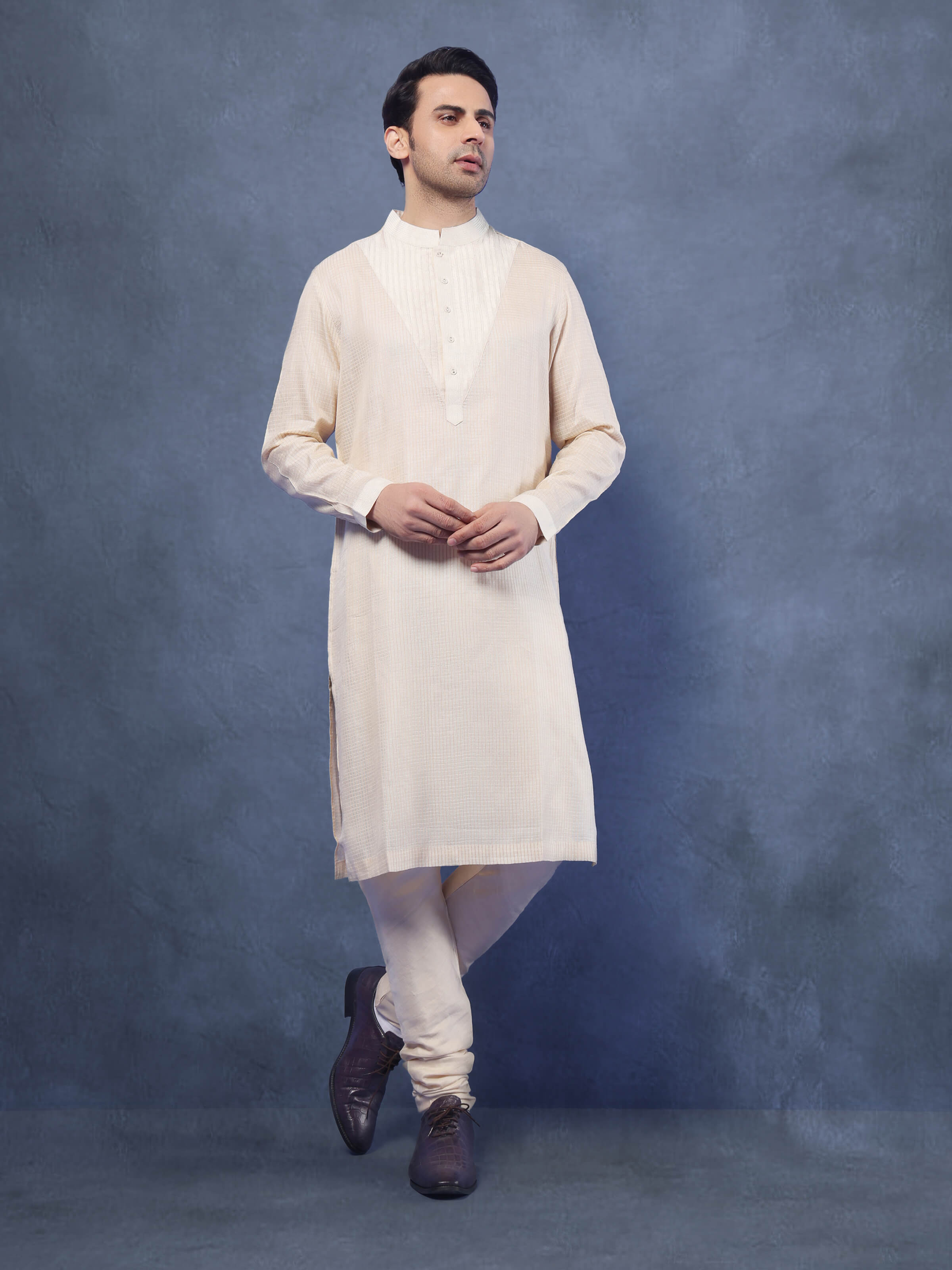 Lifestyle shot of light beige Tussar silk kurta styled with churidar, showcasing a refined ethnic look.