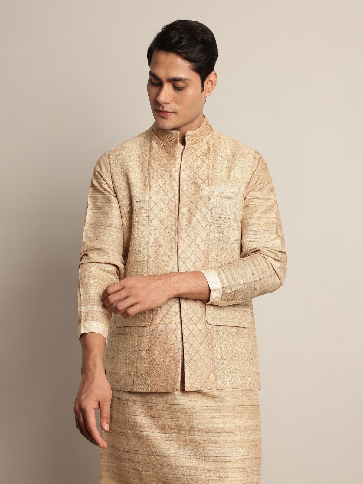 Side lifestyle view of beige Tussar jacket highlighting structure and handwoven texture.