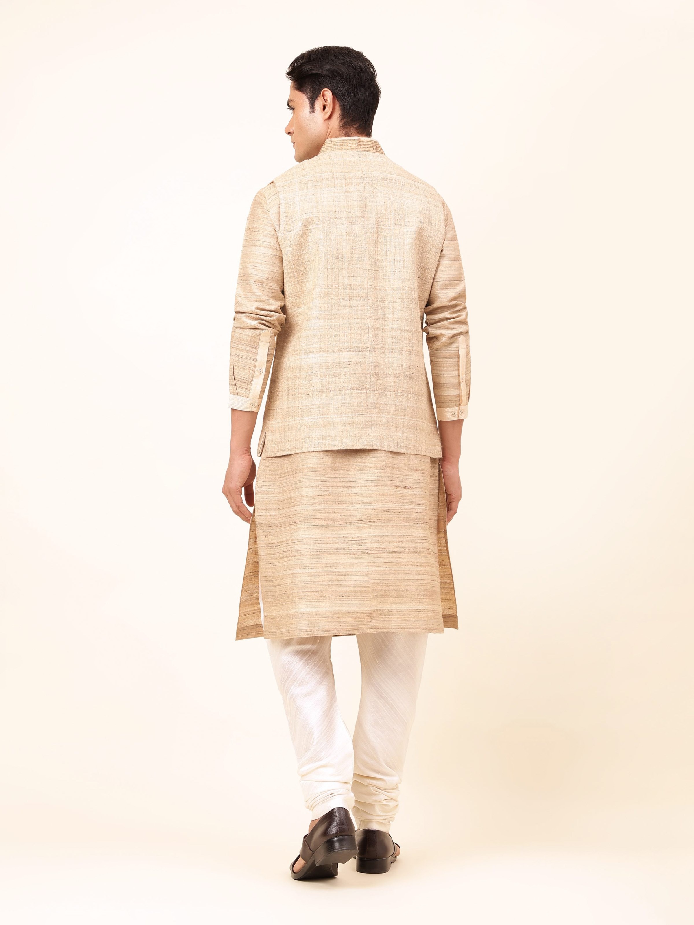 Back view of beige Tussar silk jacket revealing clean lines and tailored back panel.
