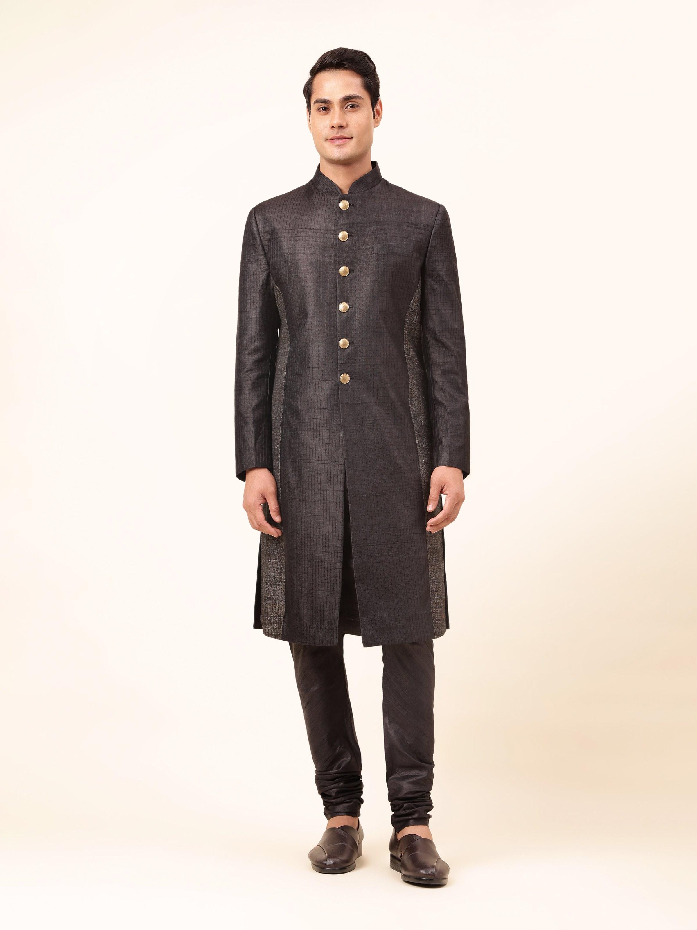 Black tussar silk sherwani displayed front-facing on a mannequin, featuring intricate embroidery and traditional button detailing.