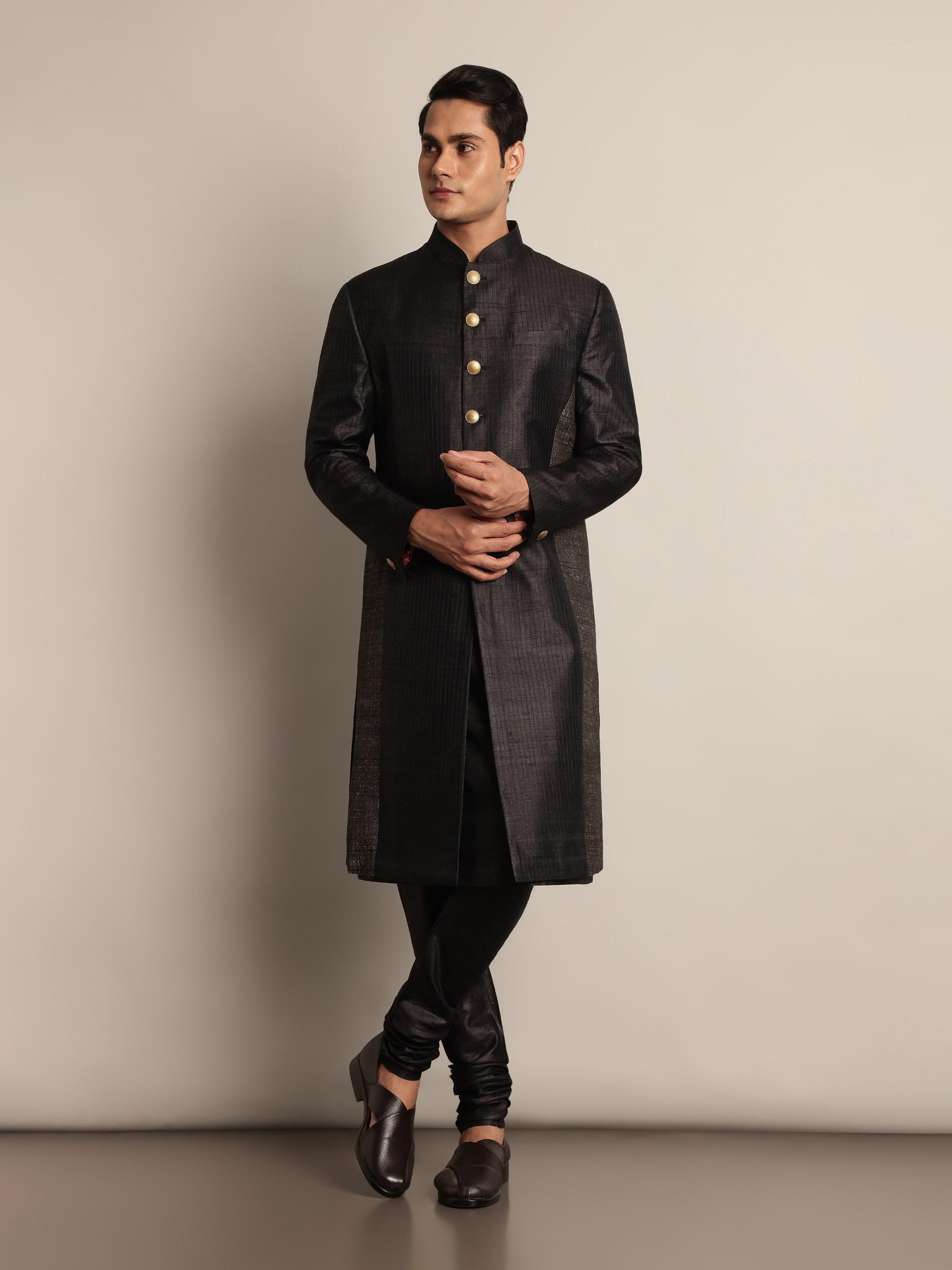 Side view of black tussar silk sherwani highlighting textured silk fabric and detailed embroidery on the sleeves and collar.