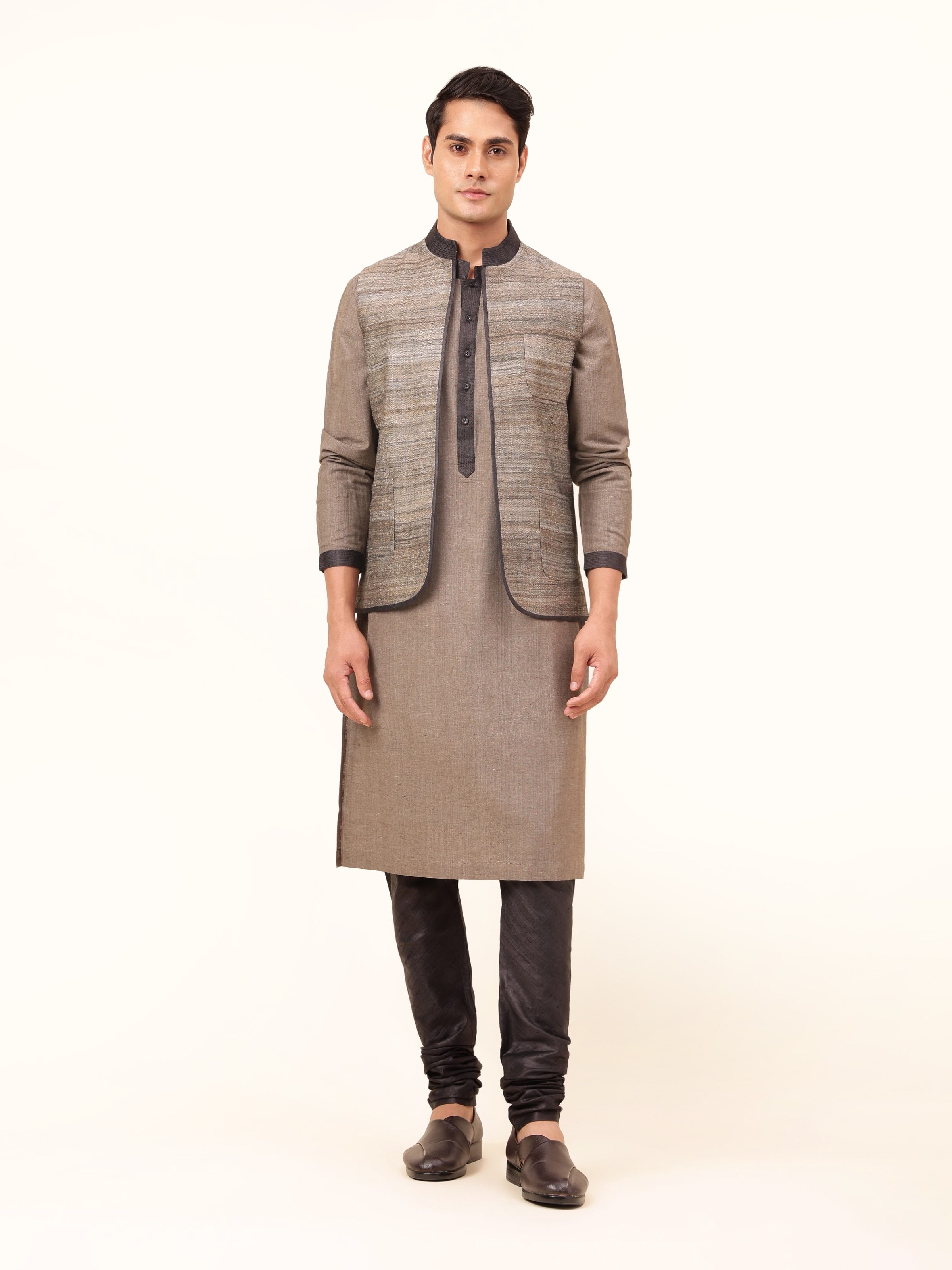 Front view of light grey Tussar silk sleeveless jacket with front opening and structured cut.