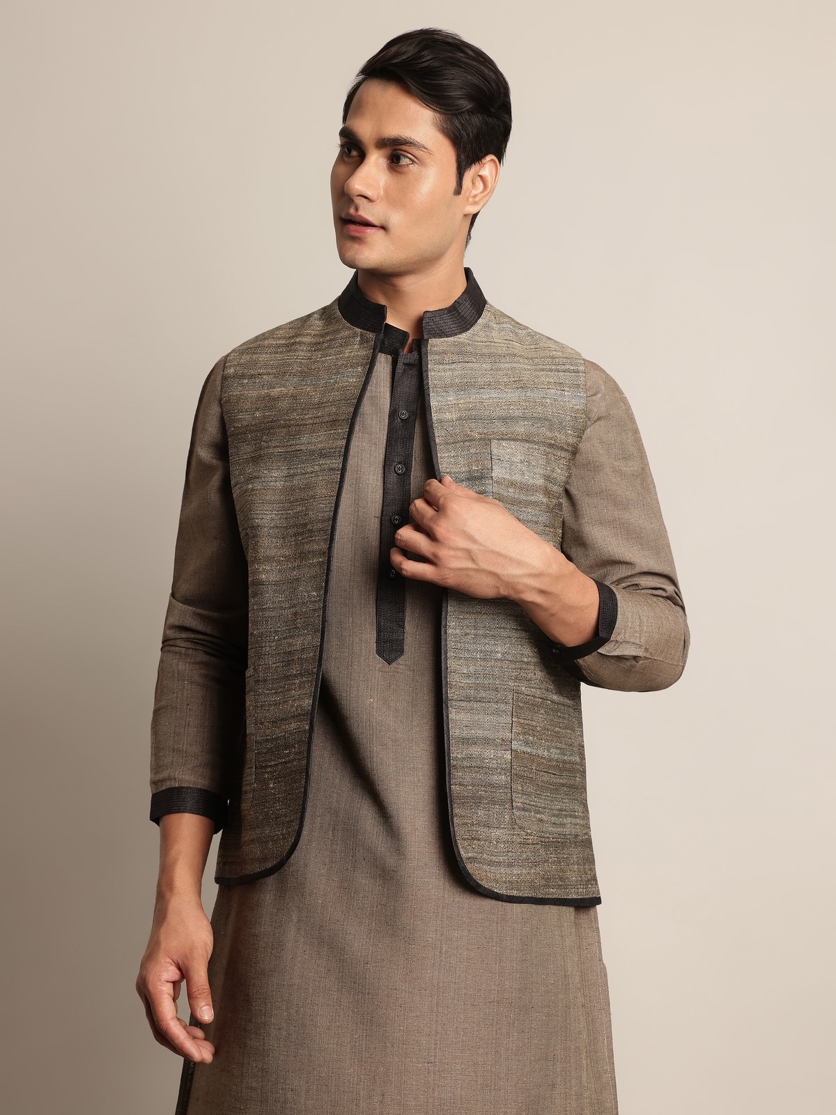 Side lifestyle view of light grey Tussar jacket showing its tailored fit and elegant drape.