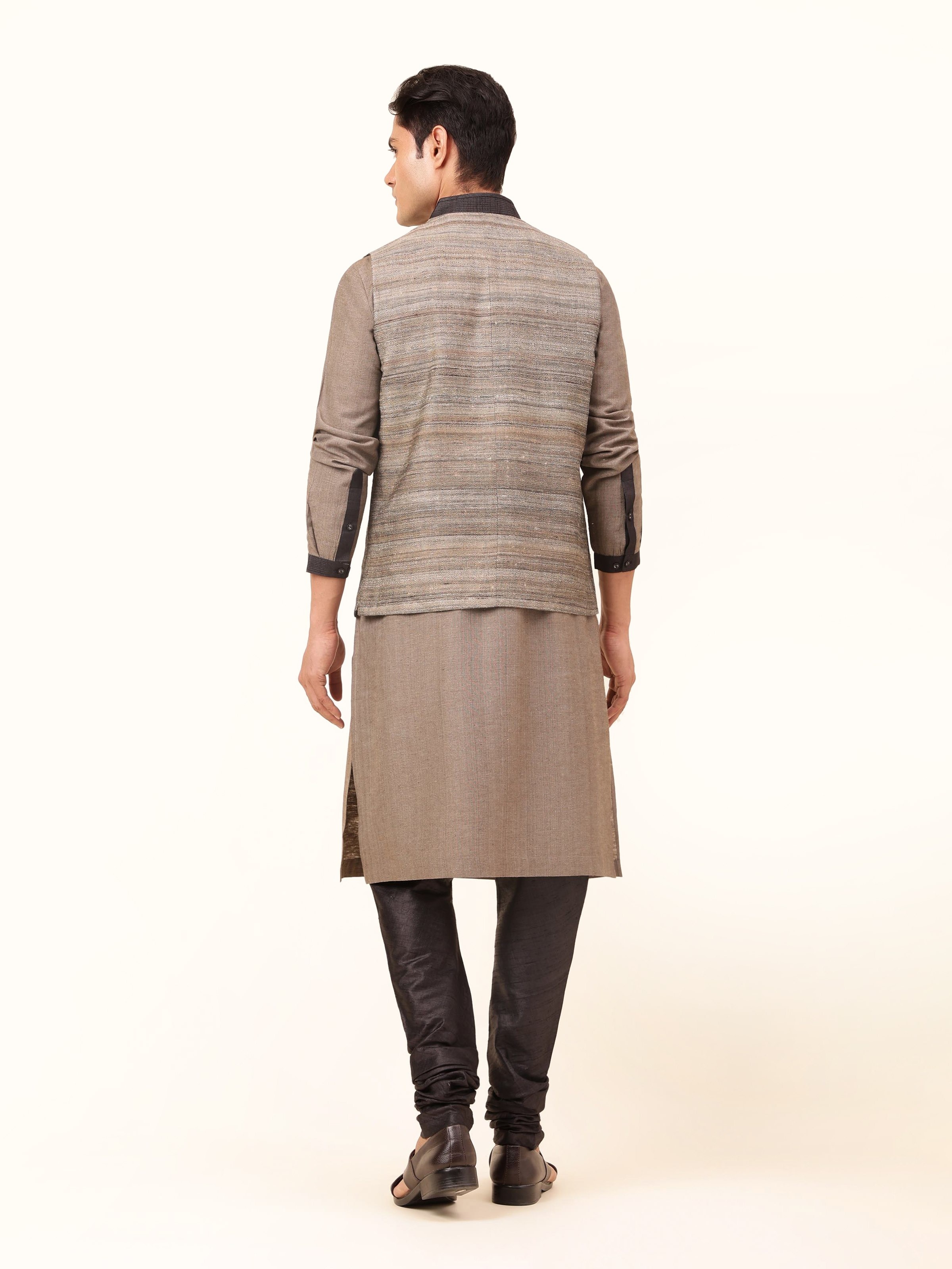 Back view of sleeveless Tussar silk jacket in light grey showing simple and clean finish.