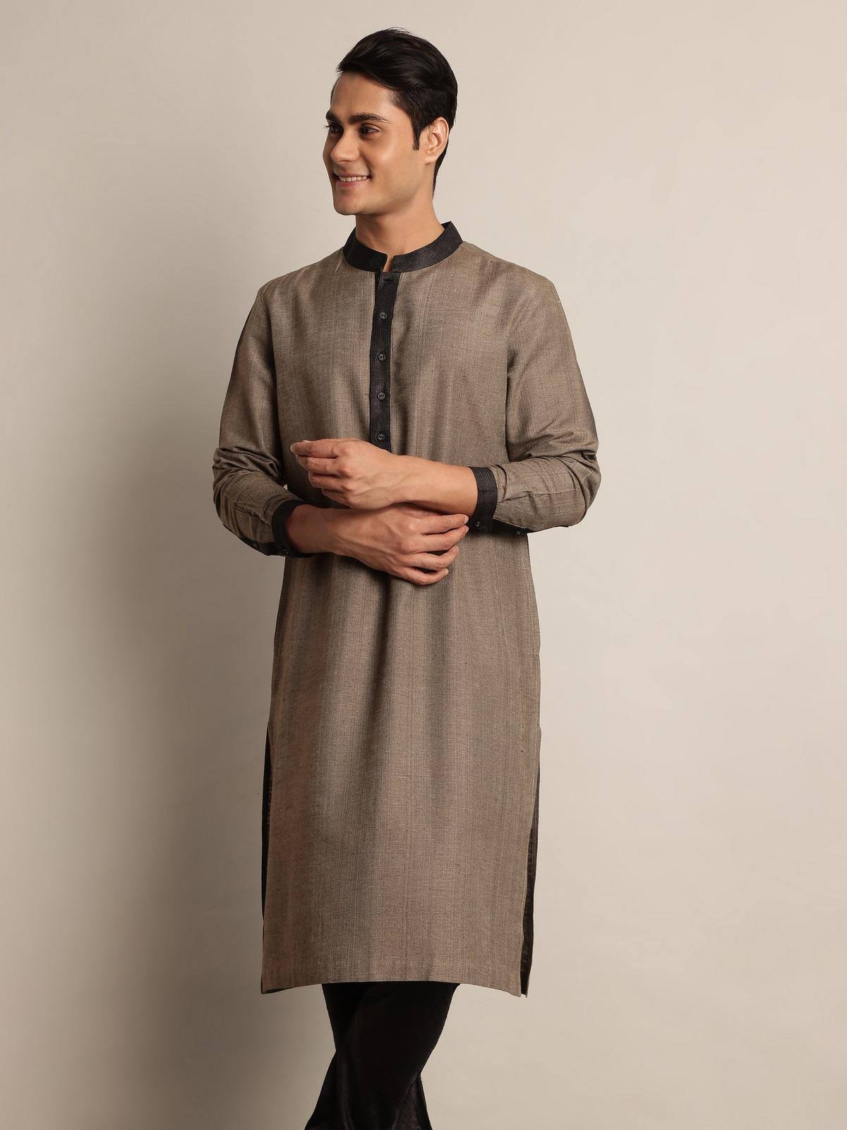 Side lifestyle view showing relaxed fit and sheen of the Tussar silk kurta.