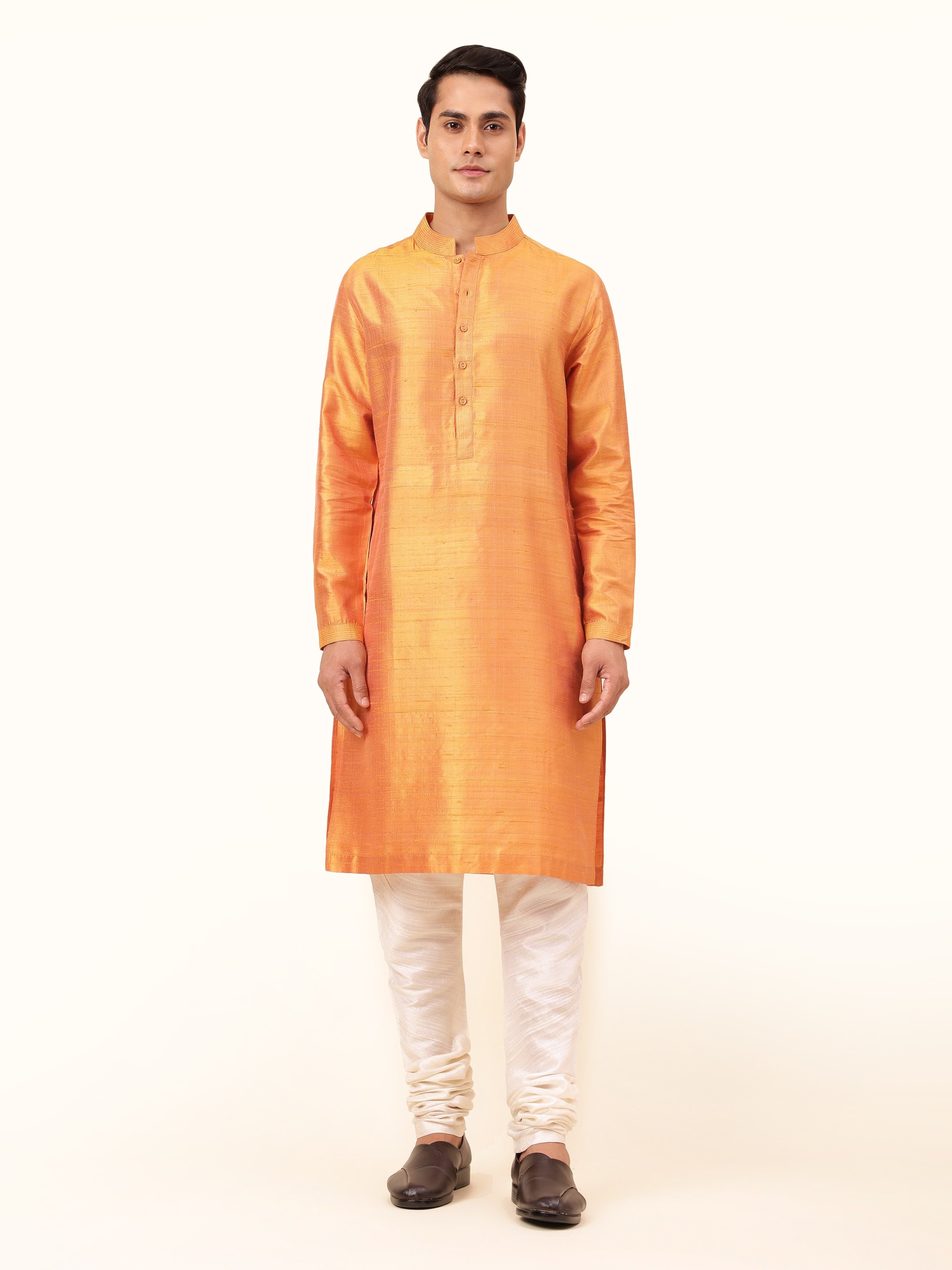 Front view highlighting the rich rust silk and refined silhouette.