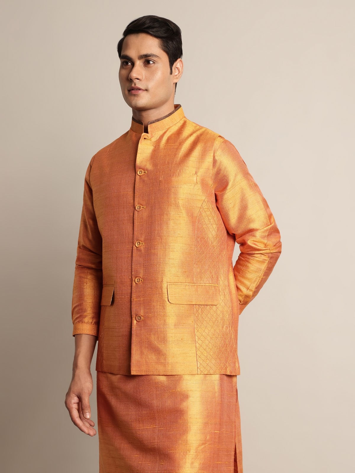 Angled view of mustard mulberry silk sleeveless jacket highlighting fabric sheen and cut