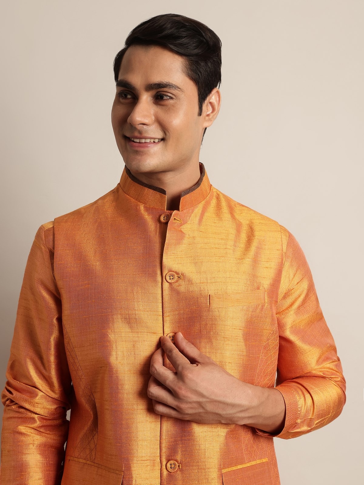 Detail shot of mustard mulberry silk sleeveless jacket showing fine silk weave and stitching