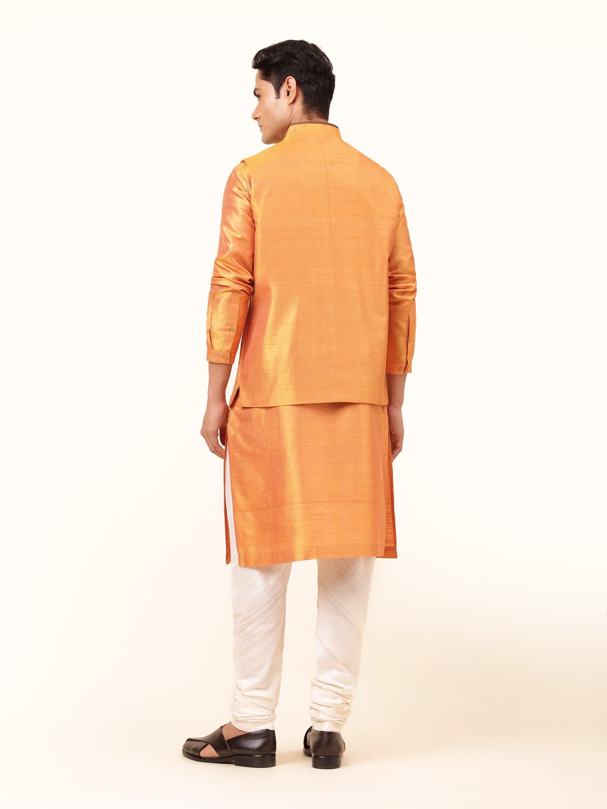 Back view of mustard mulberry silk sleeveless jacket with clean lines and neat finish