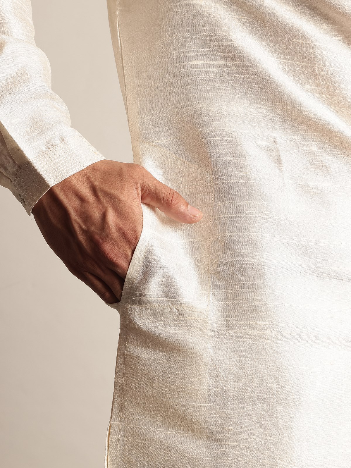 Side lifestyle view of off-white silk long kurta highlighting elegant fall and comfort