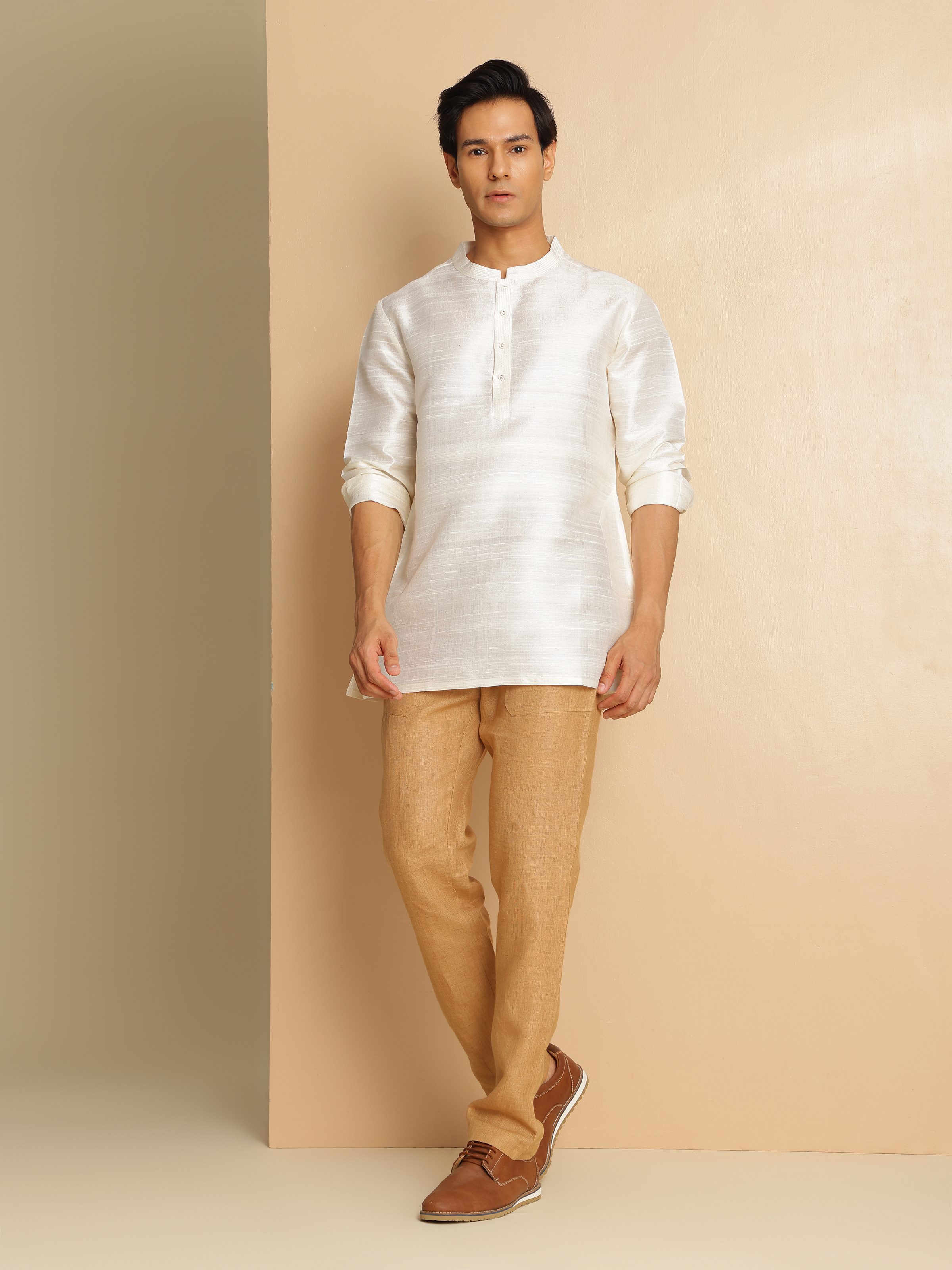 Lifestyle view of off-white mulberry silk short kurta paired with matching pants