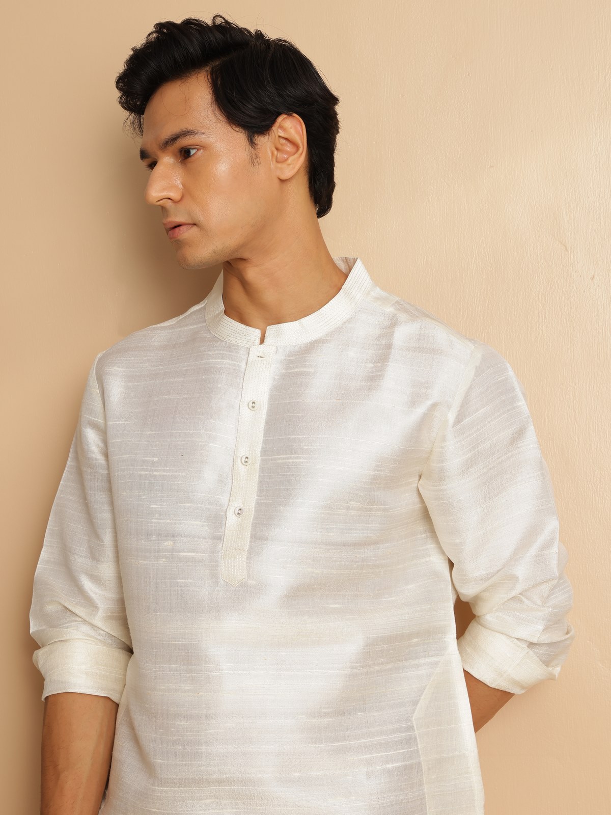 Side lifestyle view of off-white mulberry silk kurta with relaxed fit and full sleeves