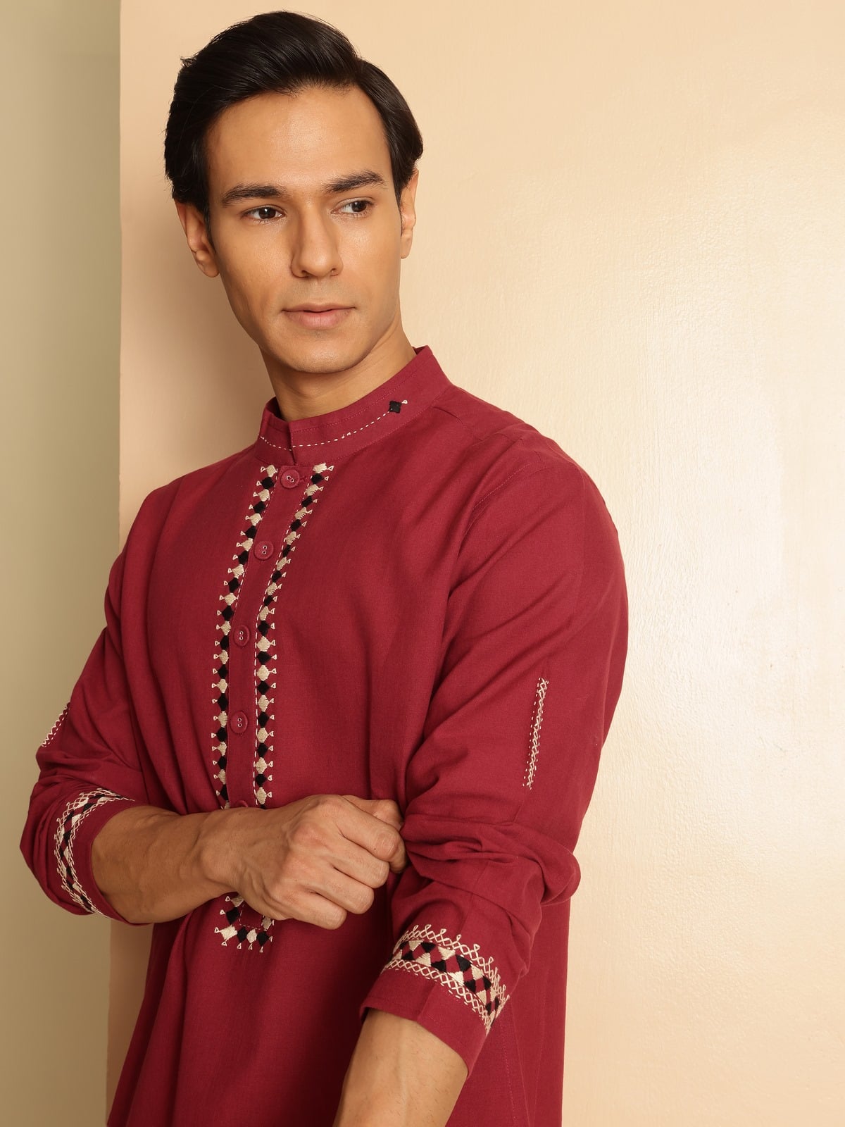 Side lifestyle view of embroidered long kurta showcasing sleeve detail and straight hem