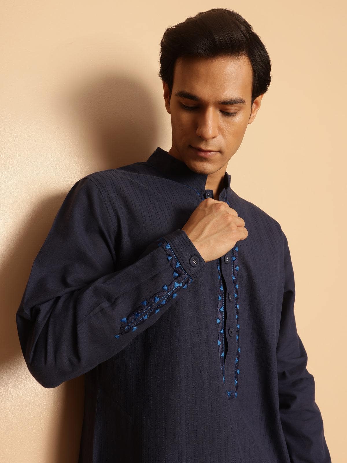 Side profile of navy blue cotton kurta highlighting traditional Soof embroidery details.