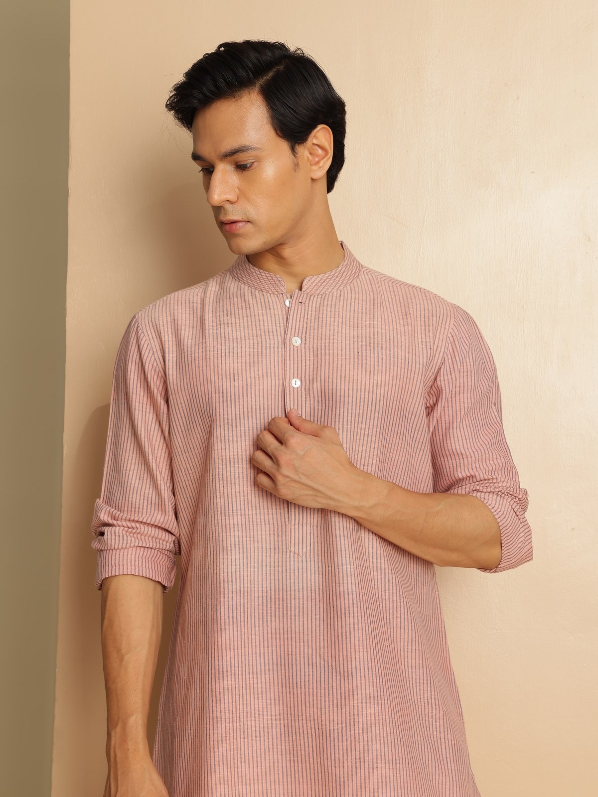 Close-up view of model in light pink cotton long kurta highlighting the straight cut and comfort fit.
