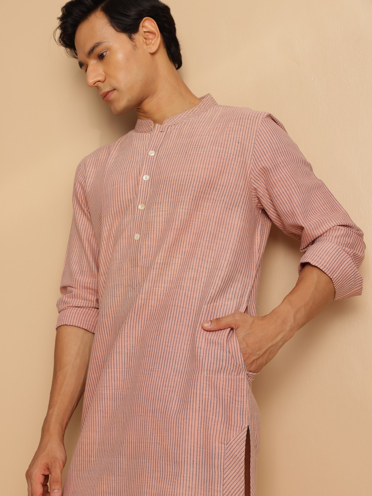 Side view of the light pink cotton long kurta showing minimal detailing and smooth finish.