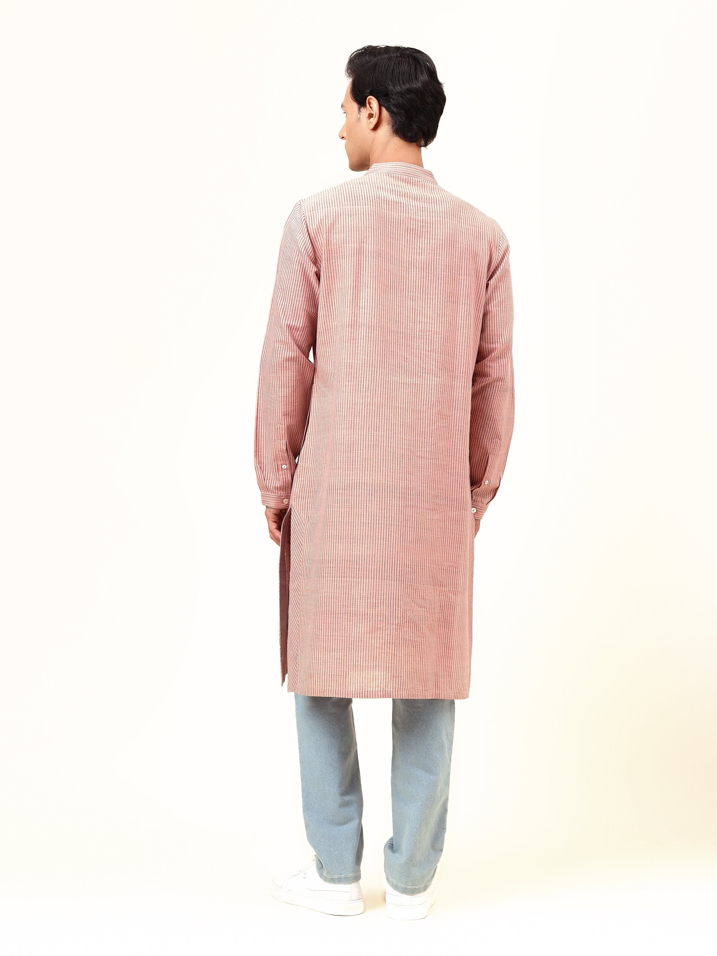Back view of the light pink cotton long kurta displaying its long silhouette and neat stitching.