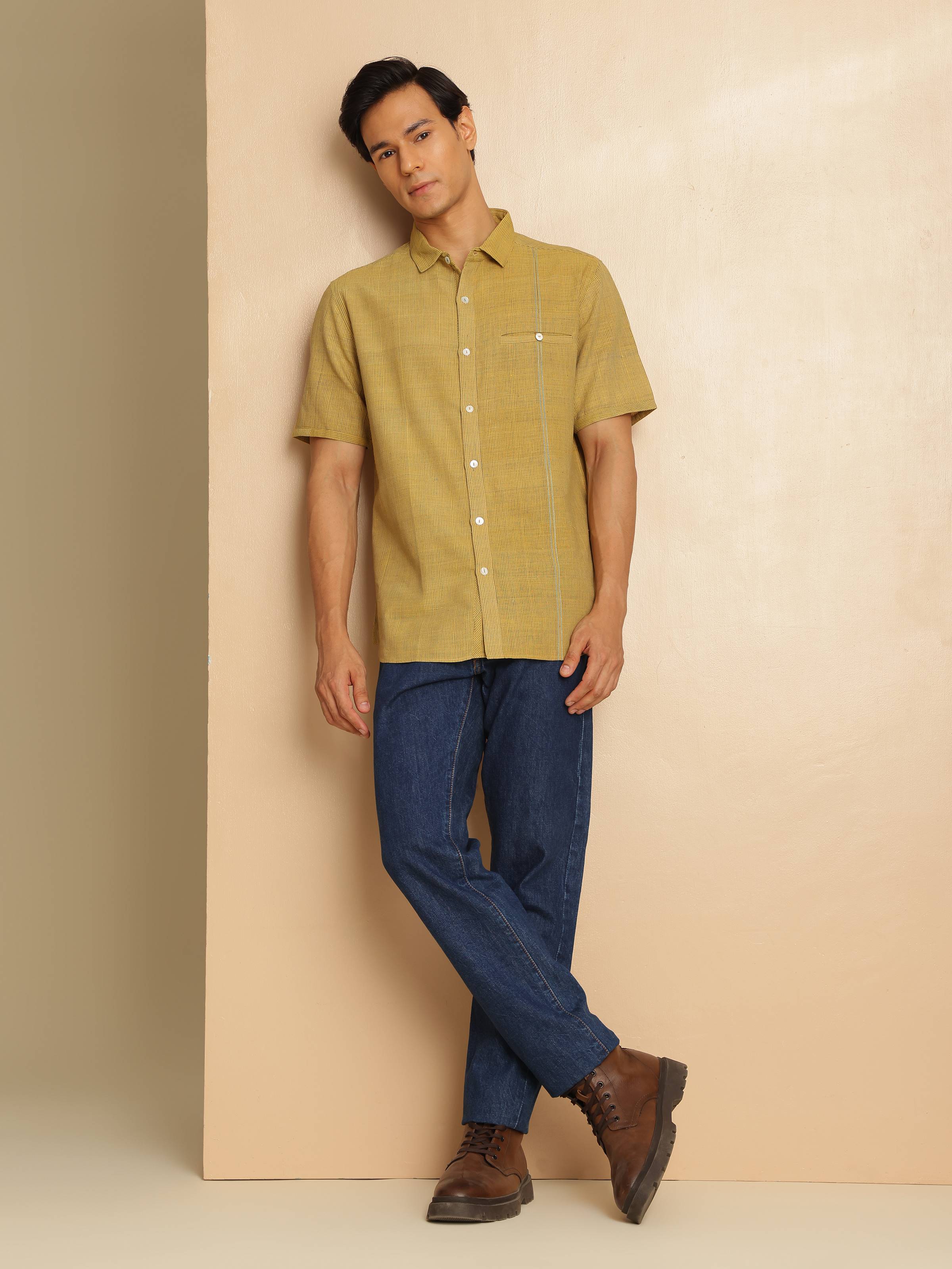 Lifestyle shot of model wearing Mustard striped cotton shirt with jeans