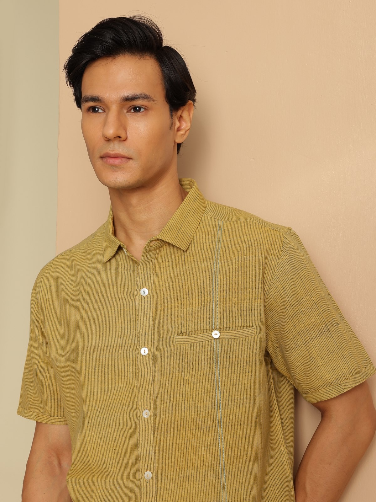 Angled view focusing on cotton fabric texture and stripe pattern on shirt