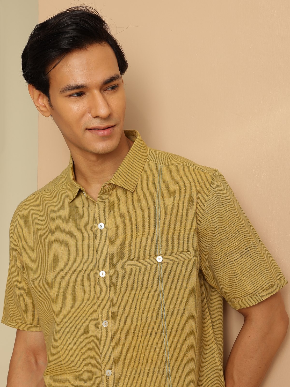 Close-up detail of cotton weave and button design on Mustard Stripes Shirt