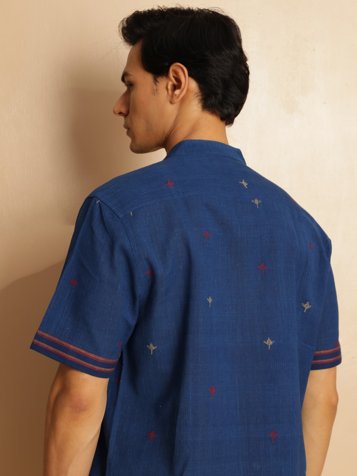 Close-up detail of buttons and collar on blue cotton shirt